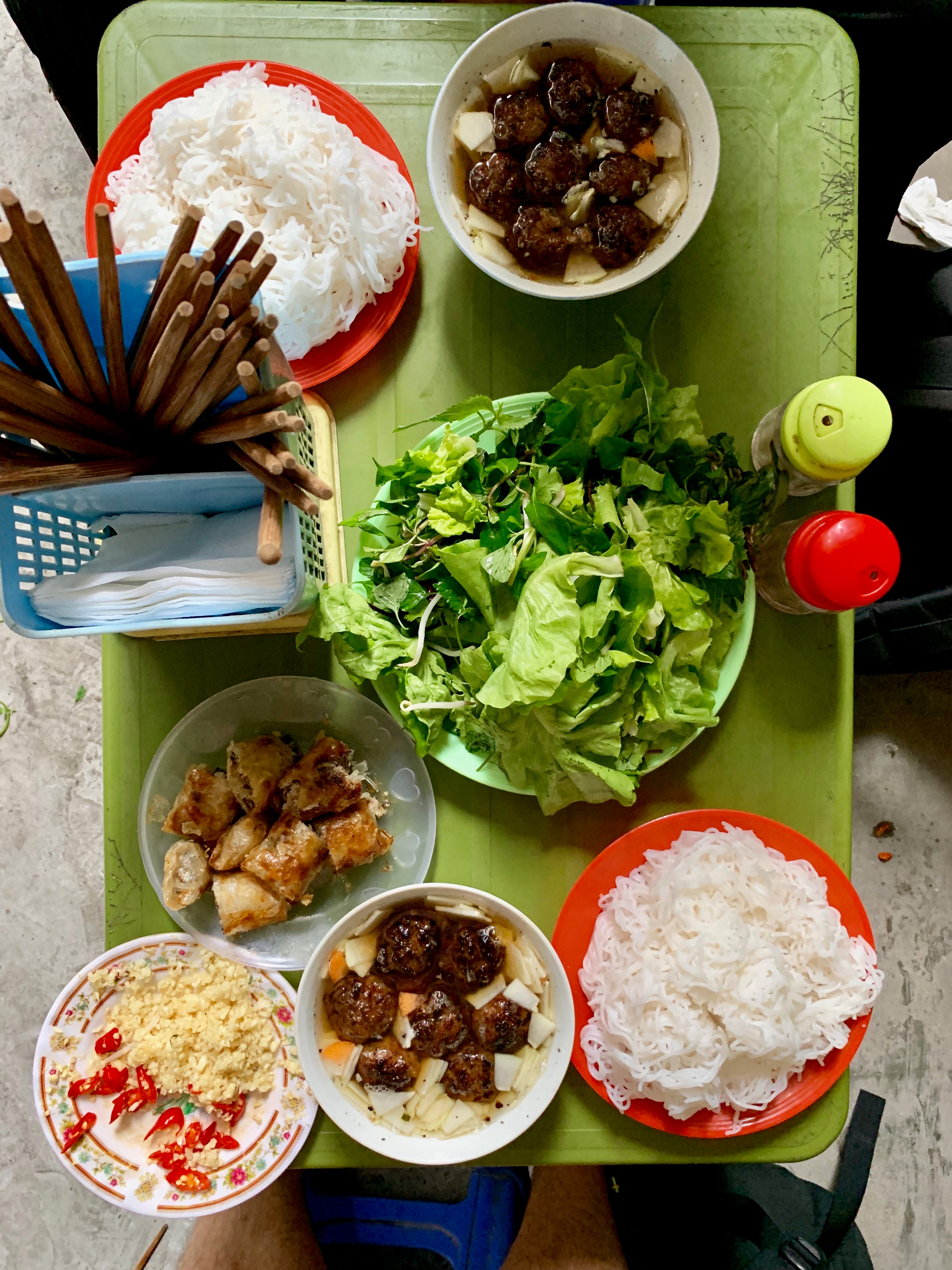 Several small bowls of food are arranged on a tabletop.