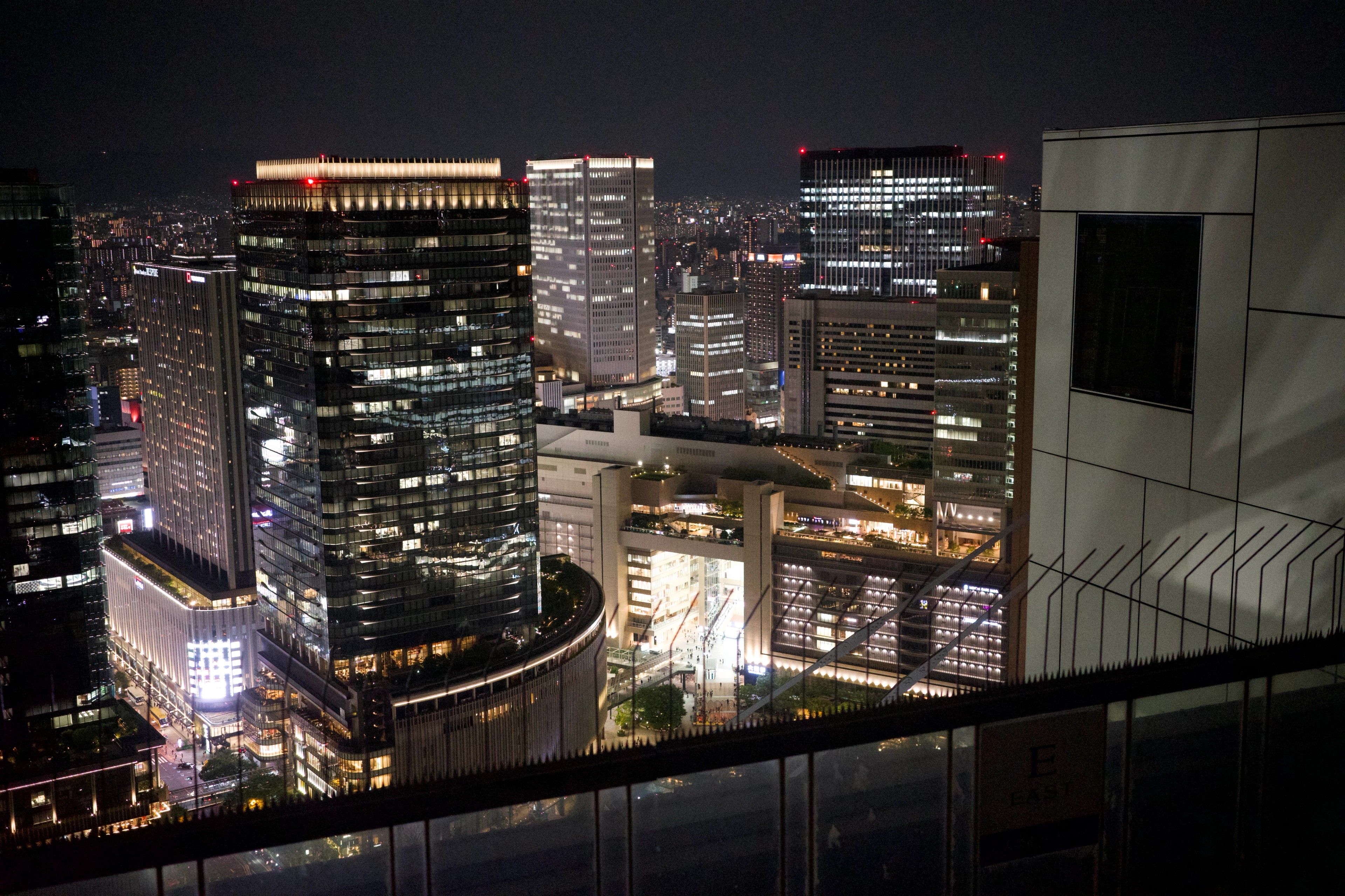 City towers and traffic lights viewed from above at night.