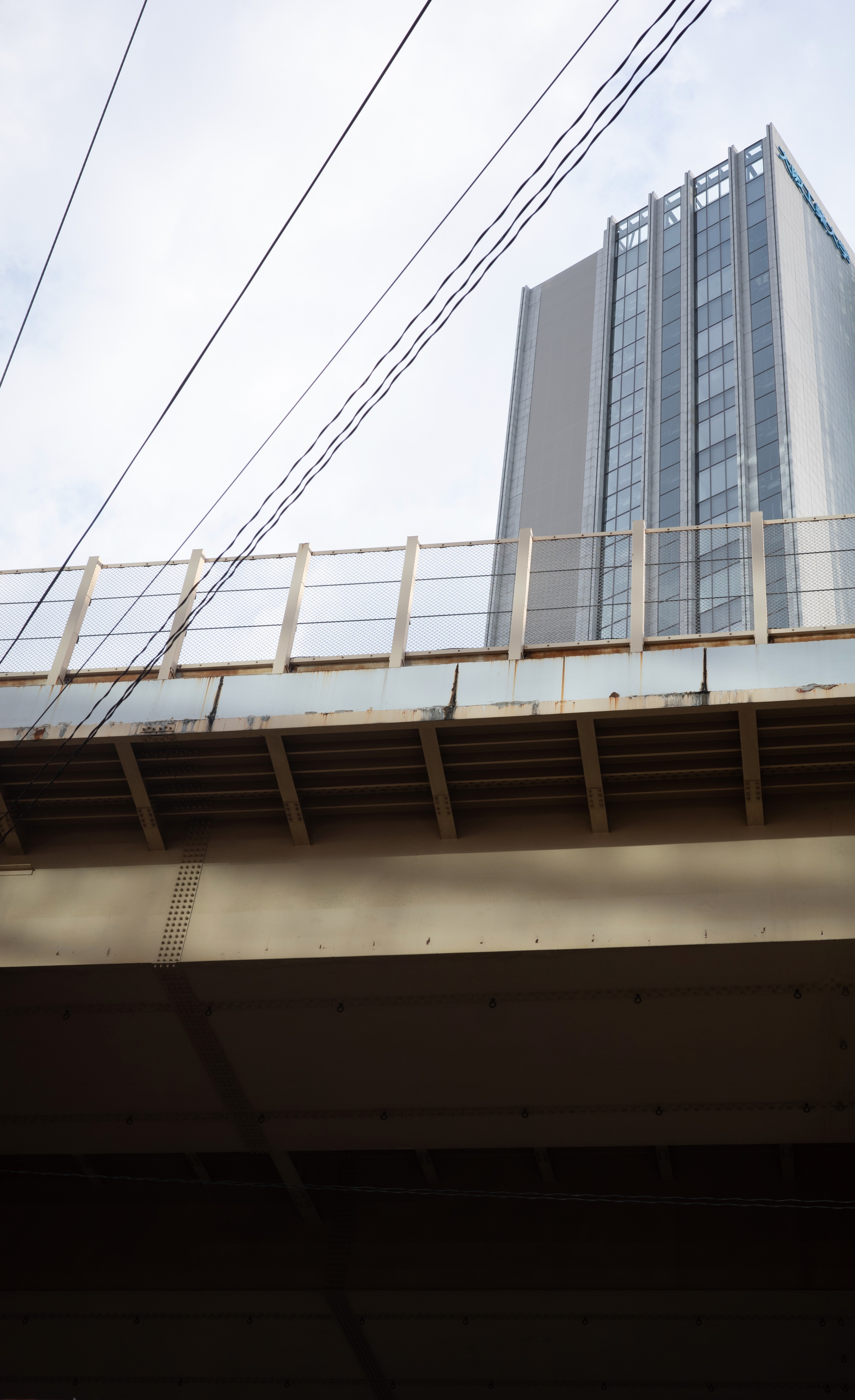 A pedestrian bridge spans a city road.