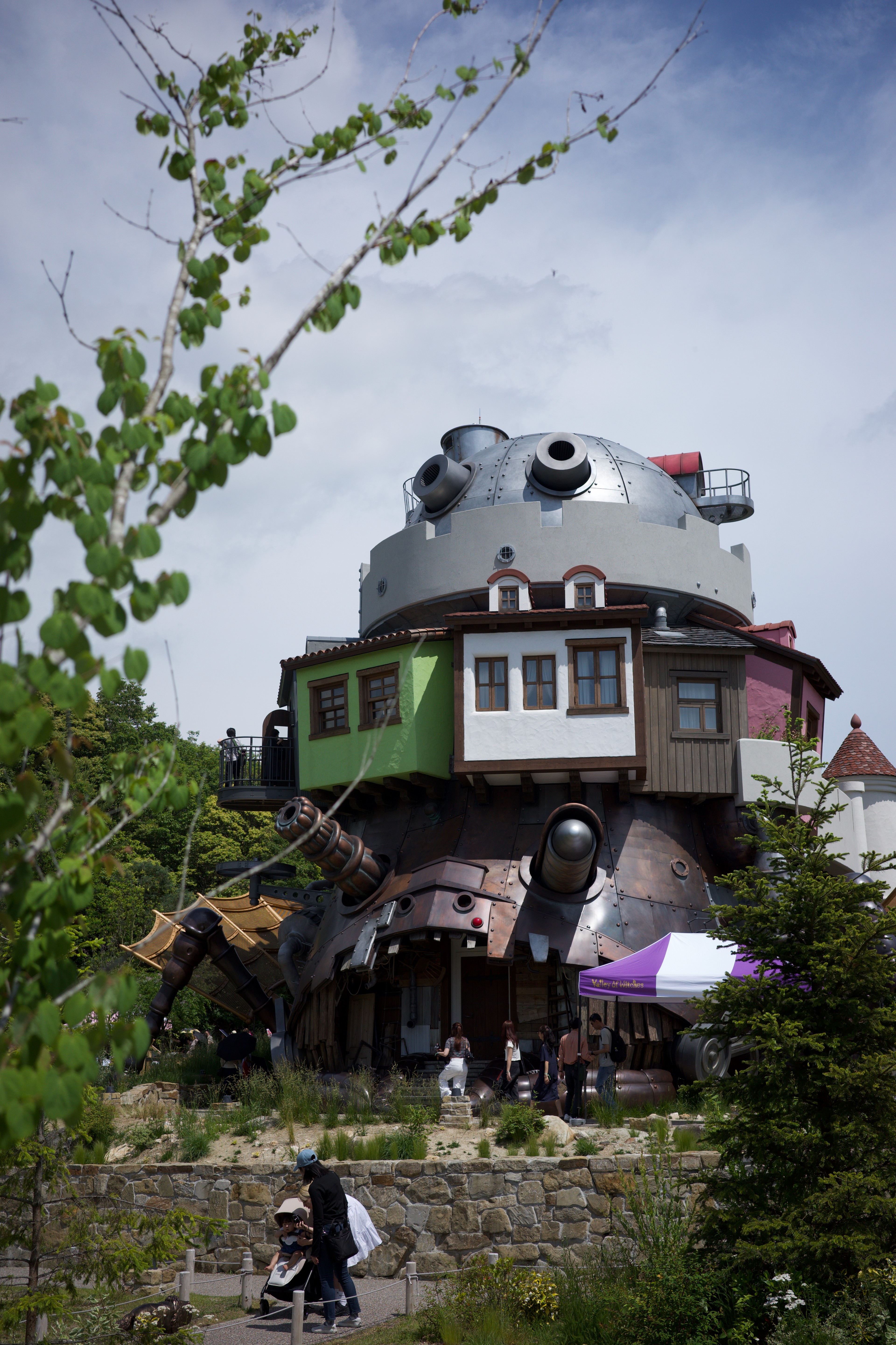 A locomotive-shaped attraction rises above the trees.