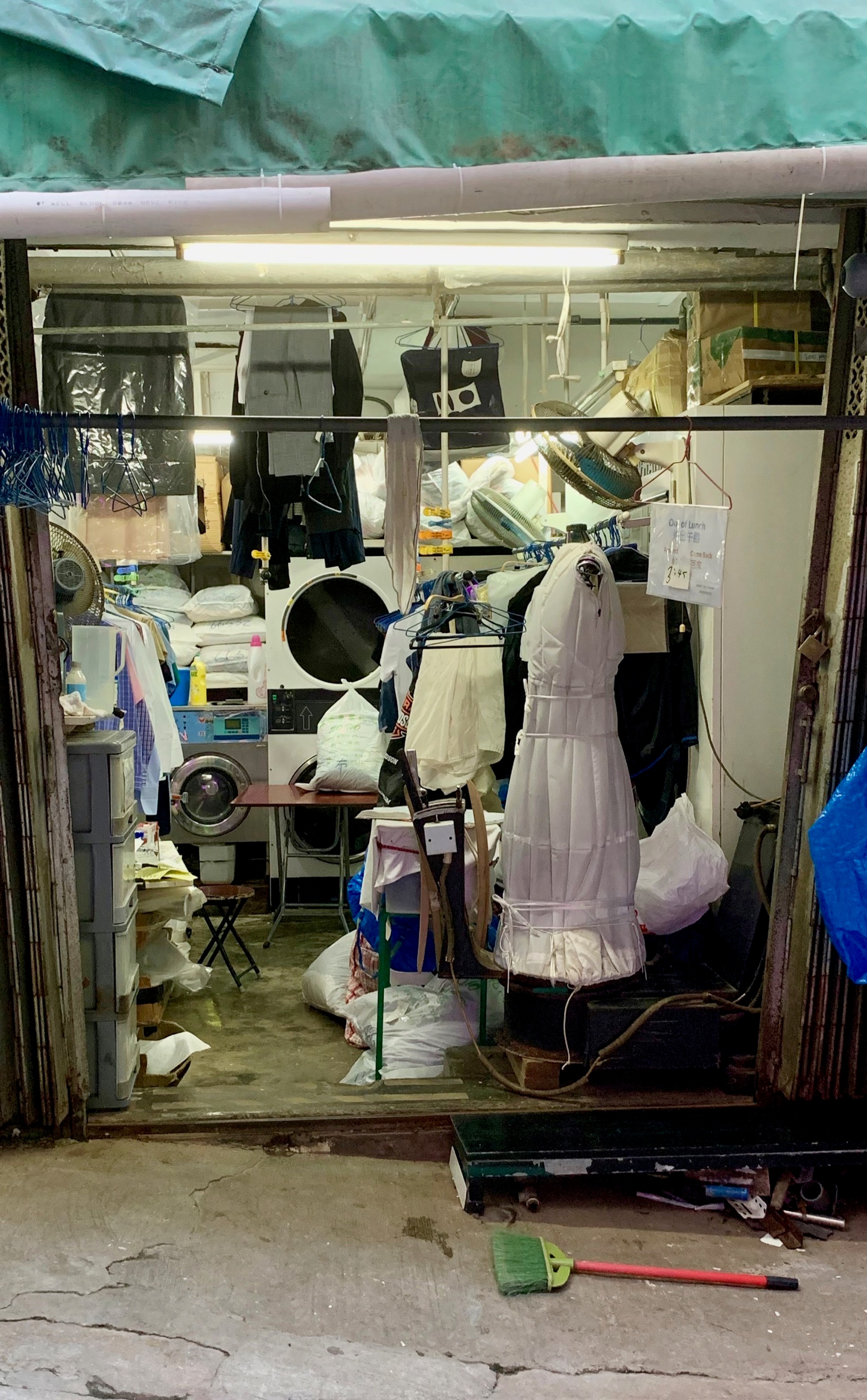 A small laundry shop in a narrow Hong Kong alley.