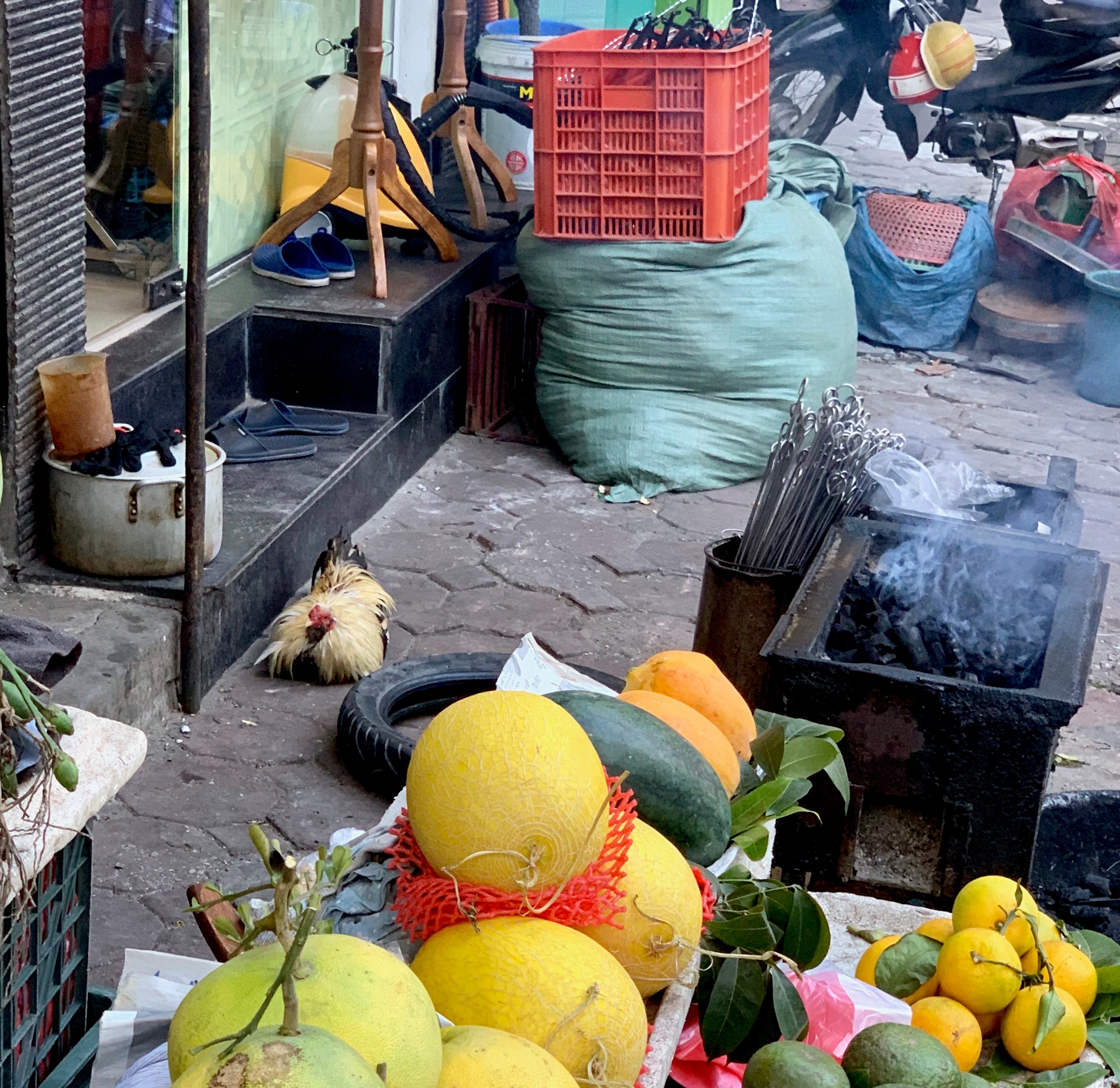 Yellow and green citrus fruit is piled in a market basket.