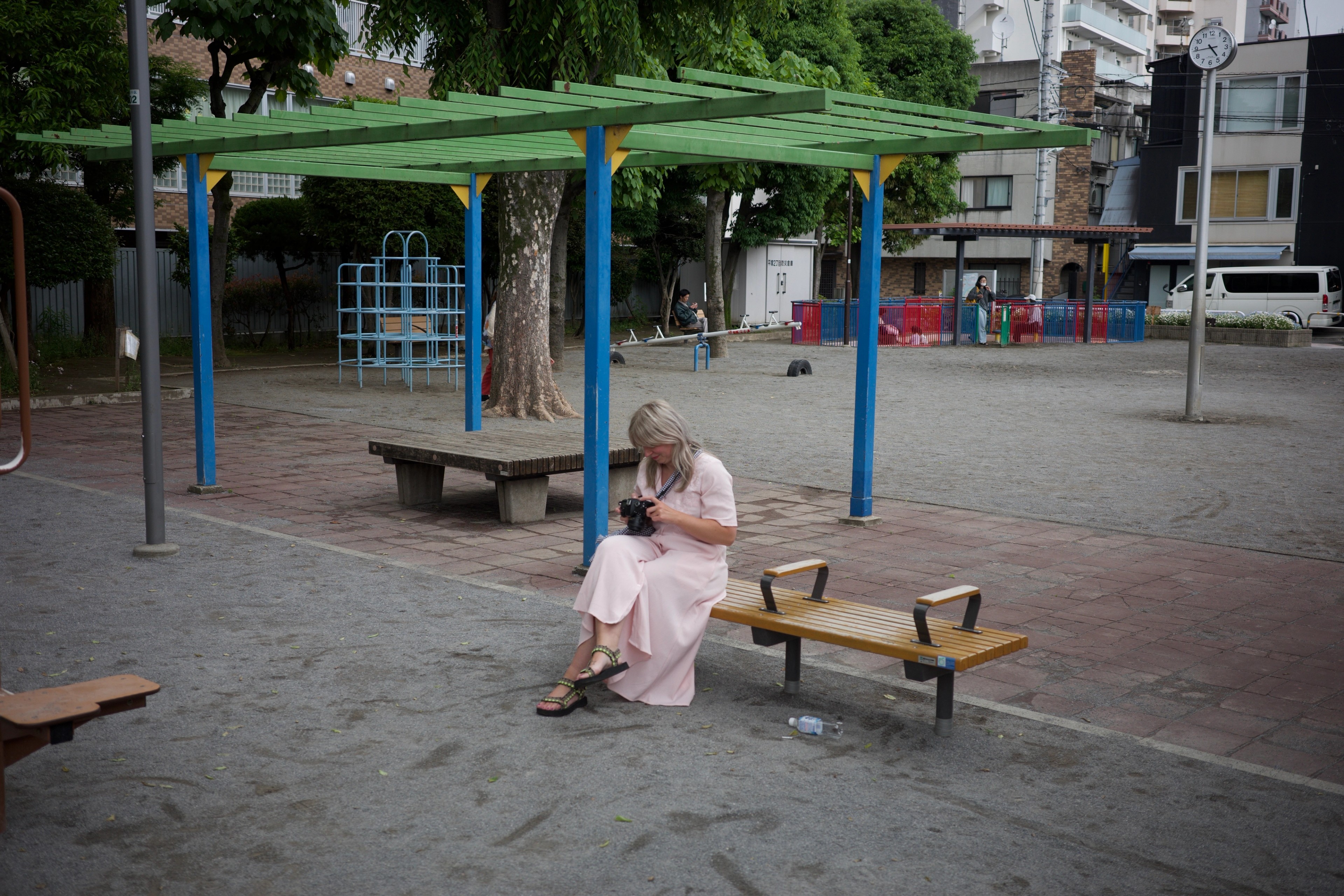 A child playing at a small neighborhood playground.