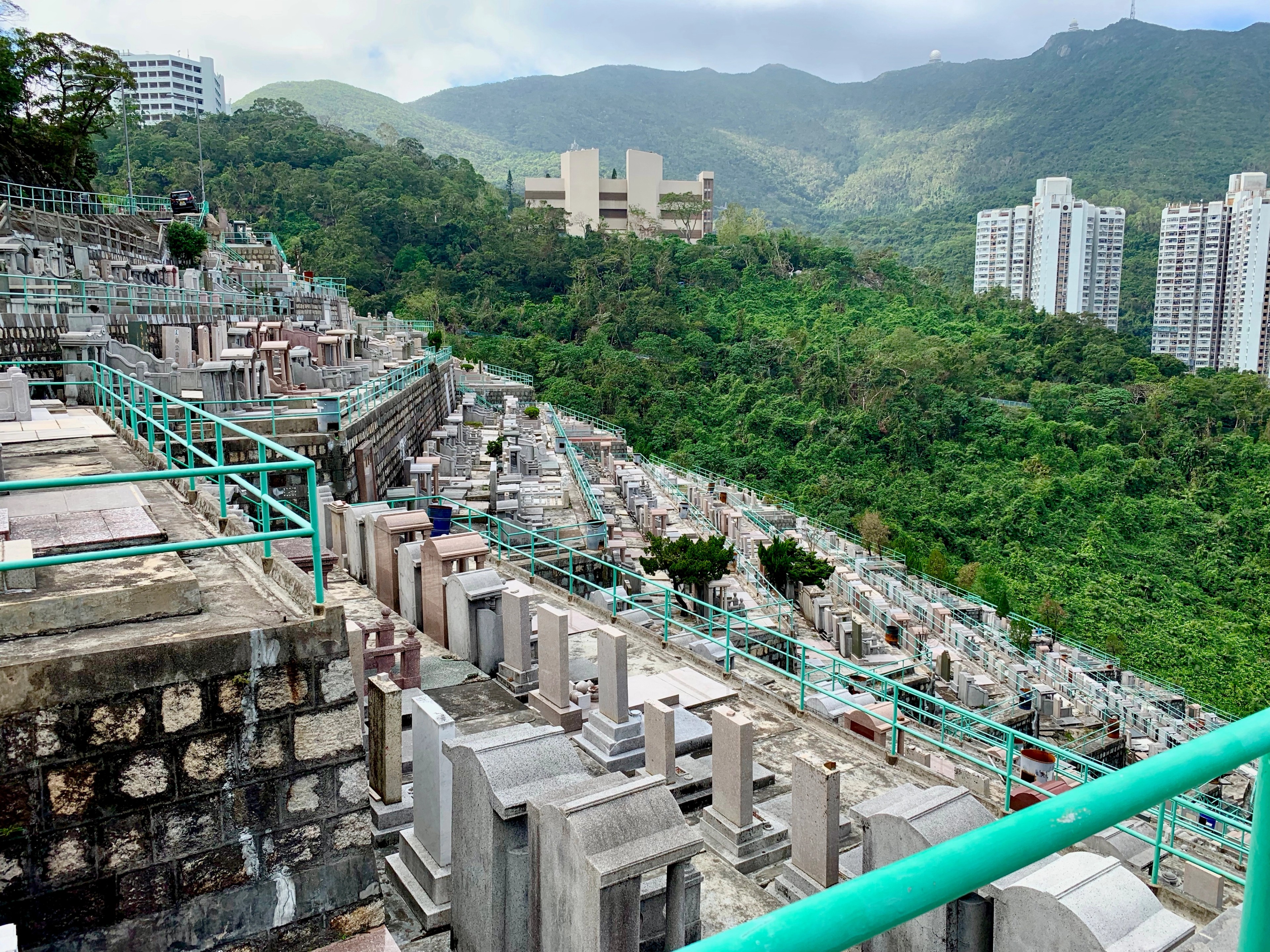 Rows of hillside graves and tombstones in a Hong Kong cemetery.