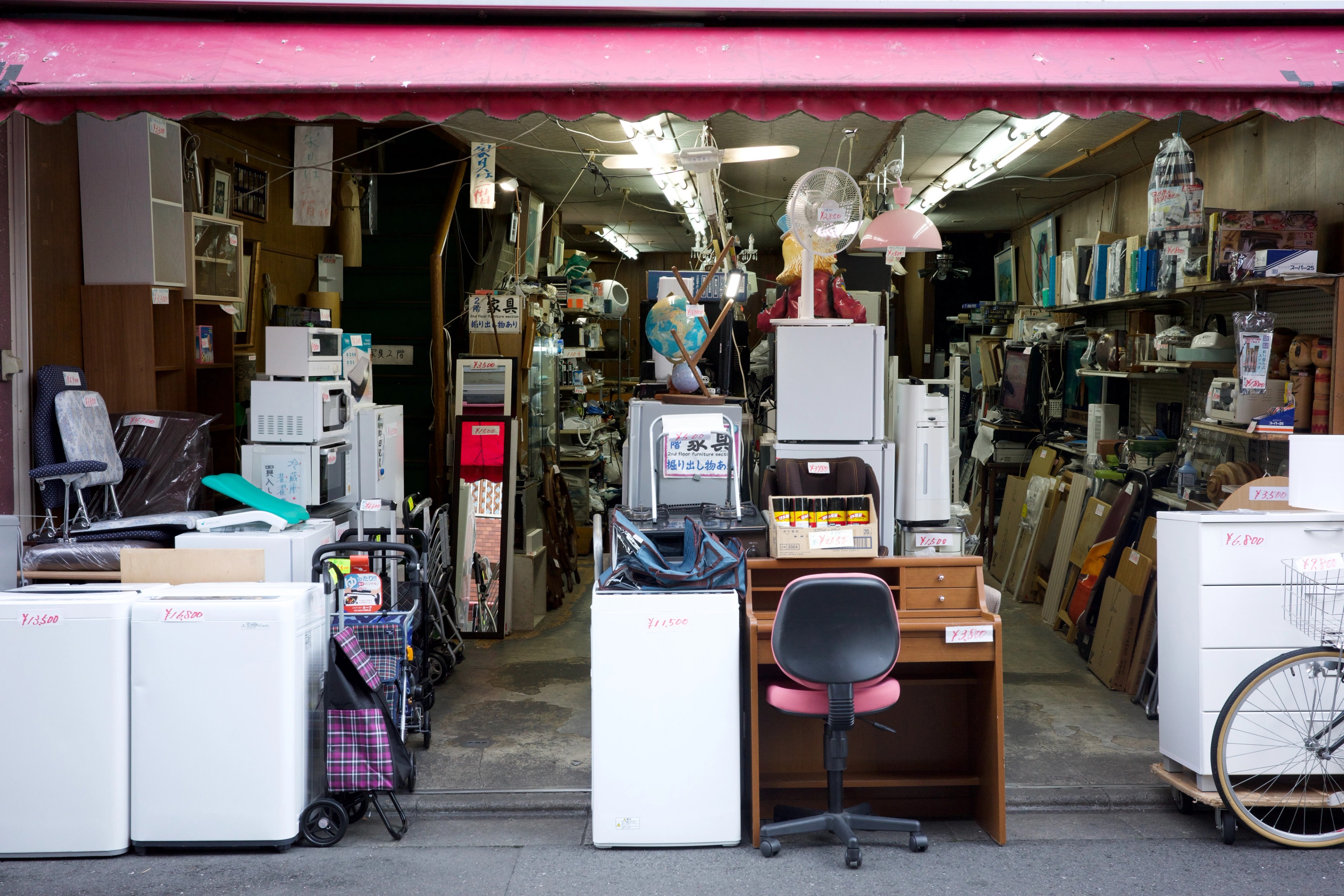 A small shop is packed with appliances and household goods.