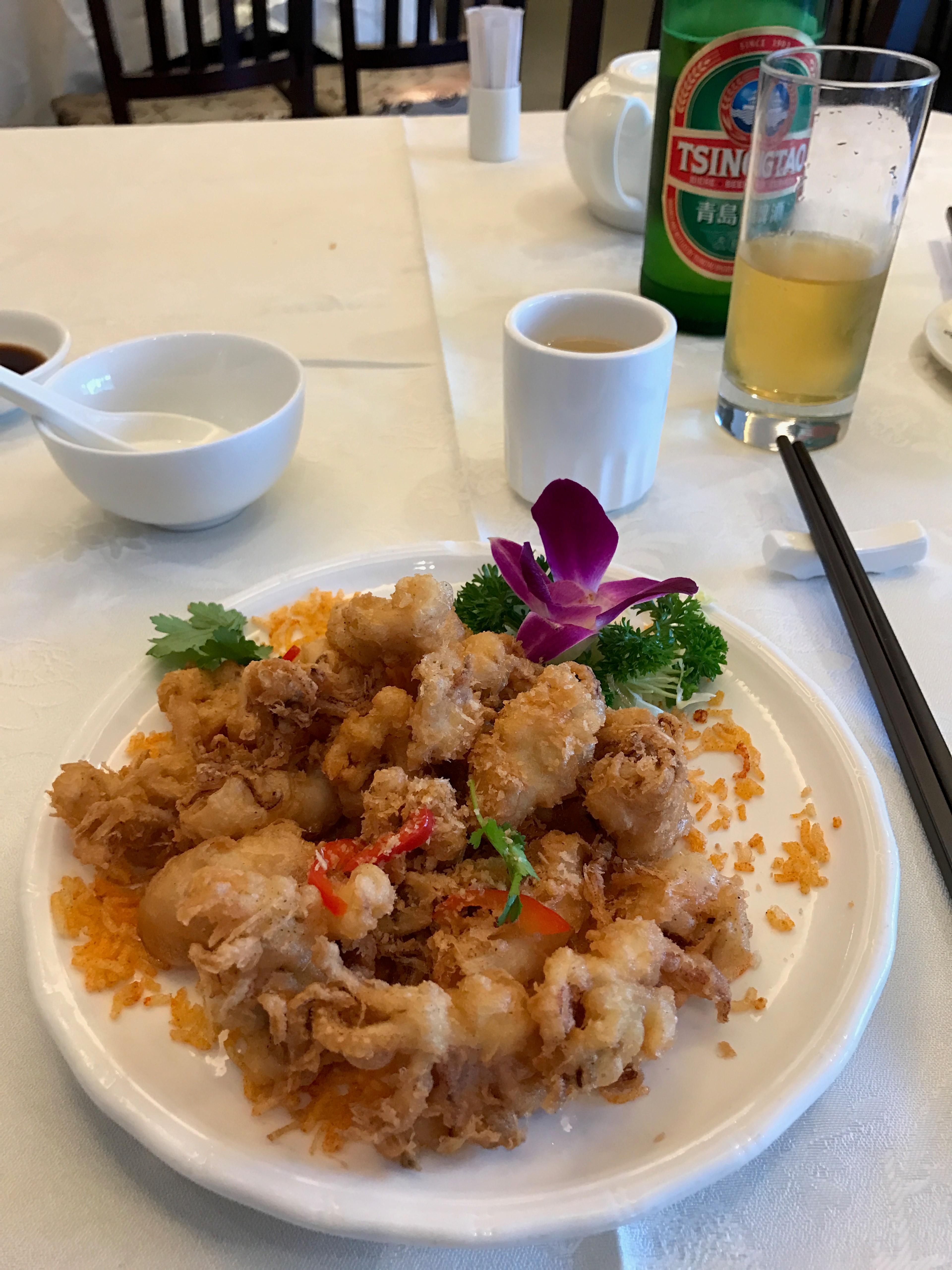 A plate of rice and vegetables is served at a table.