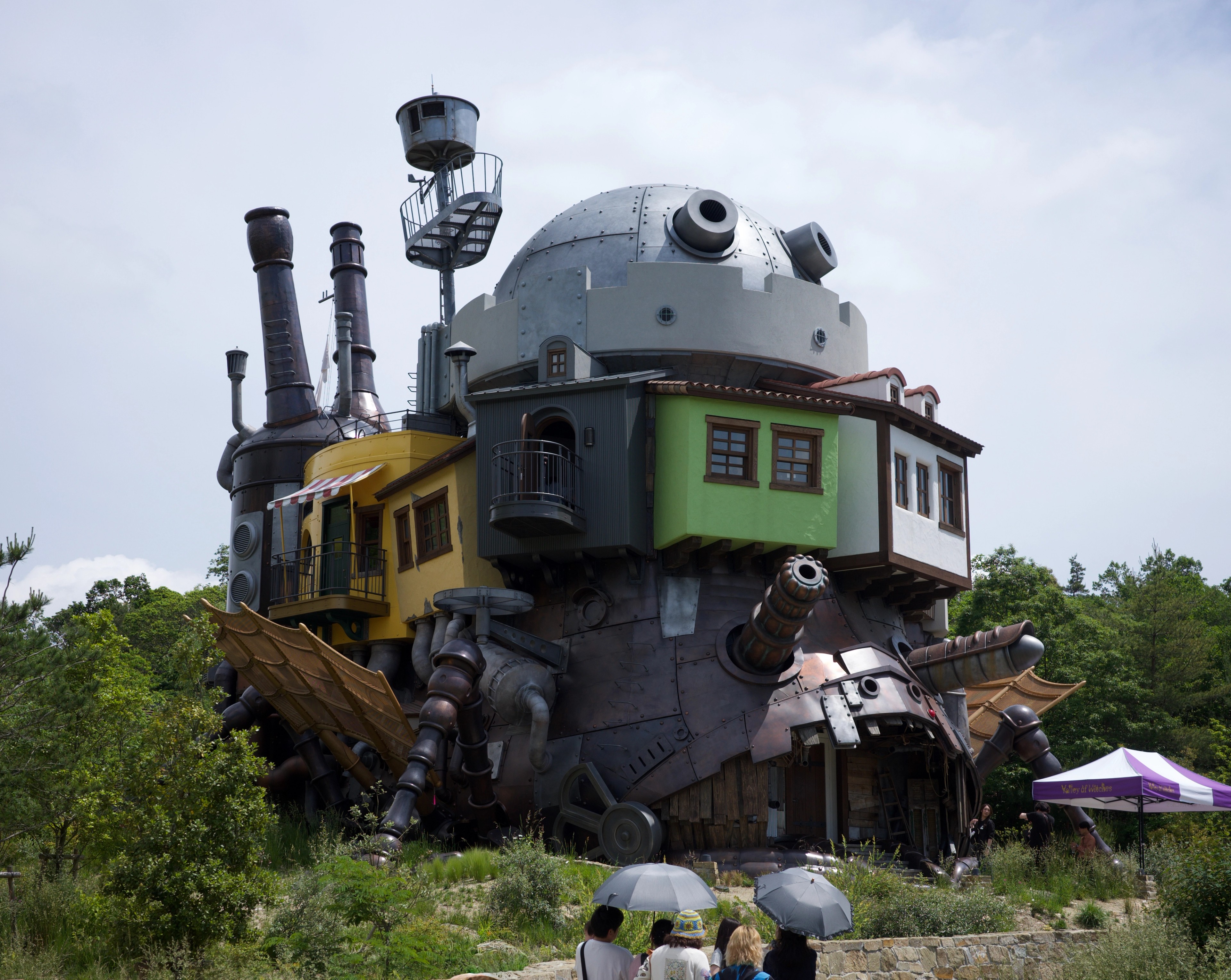 A locomotive-shaped attraction stands among trees.