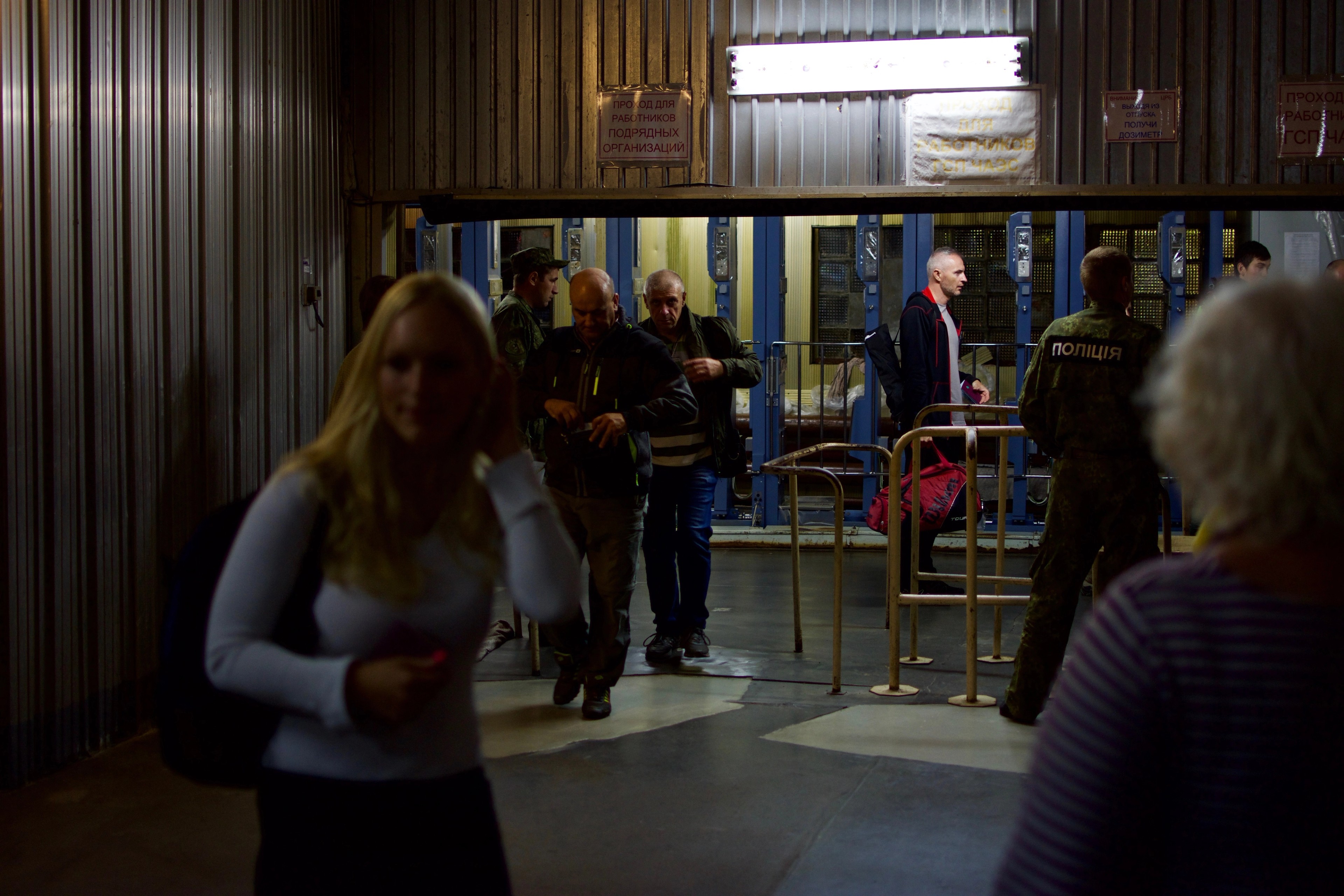 Passengers walk through a brightly lit station concourse.