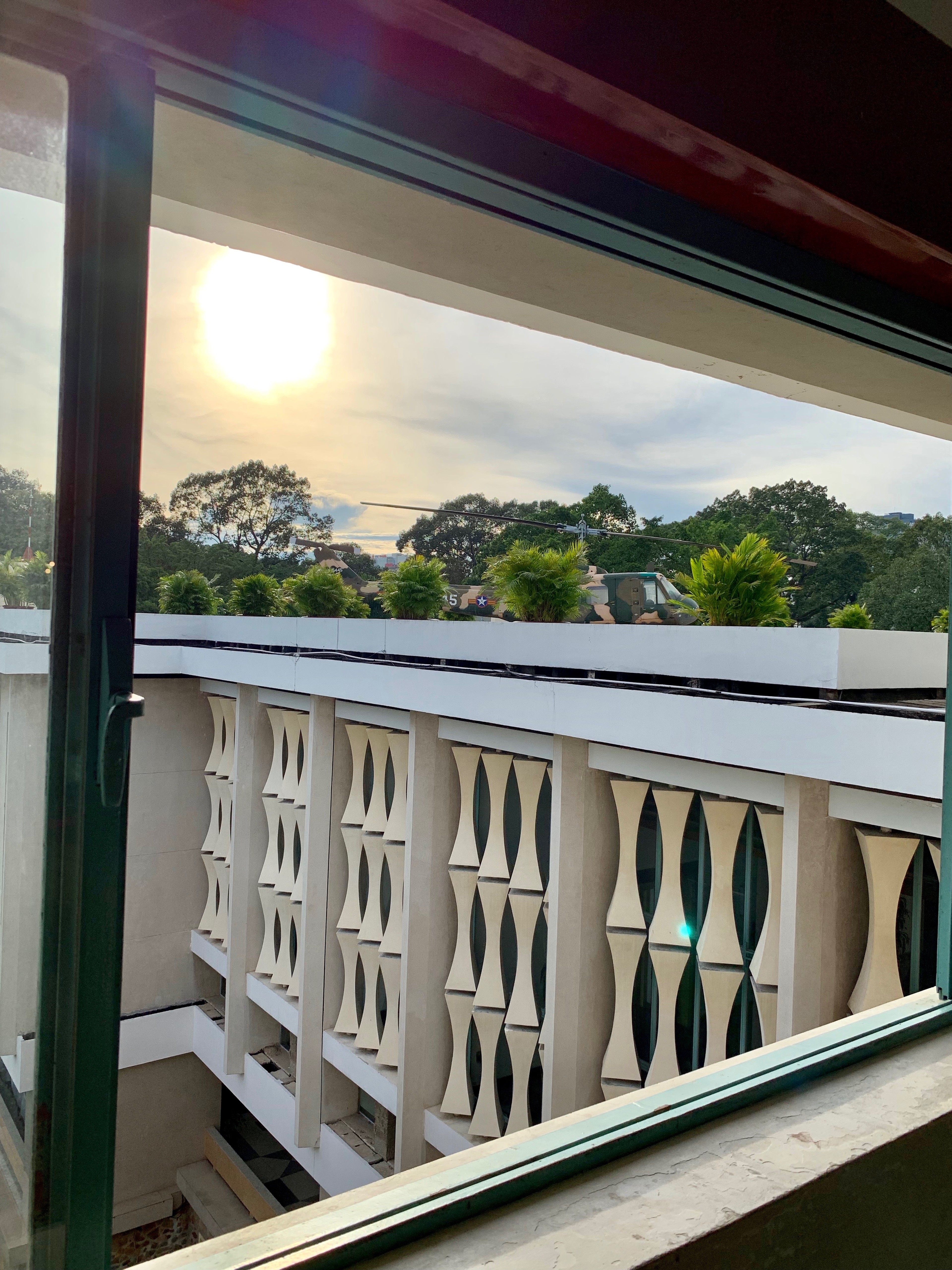 A balcony overlooks a green courtyard and surrounding buildings.