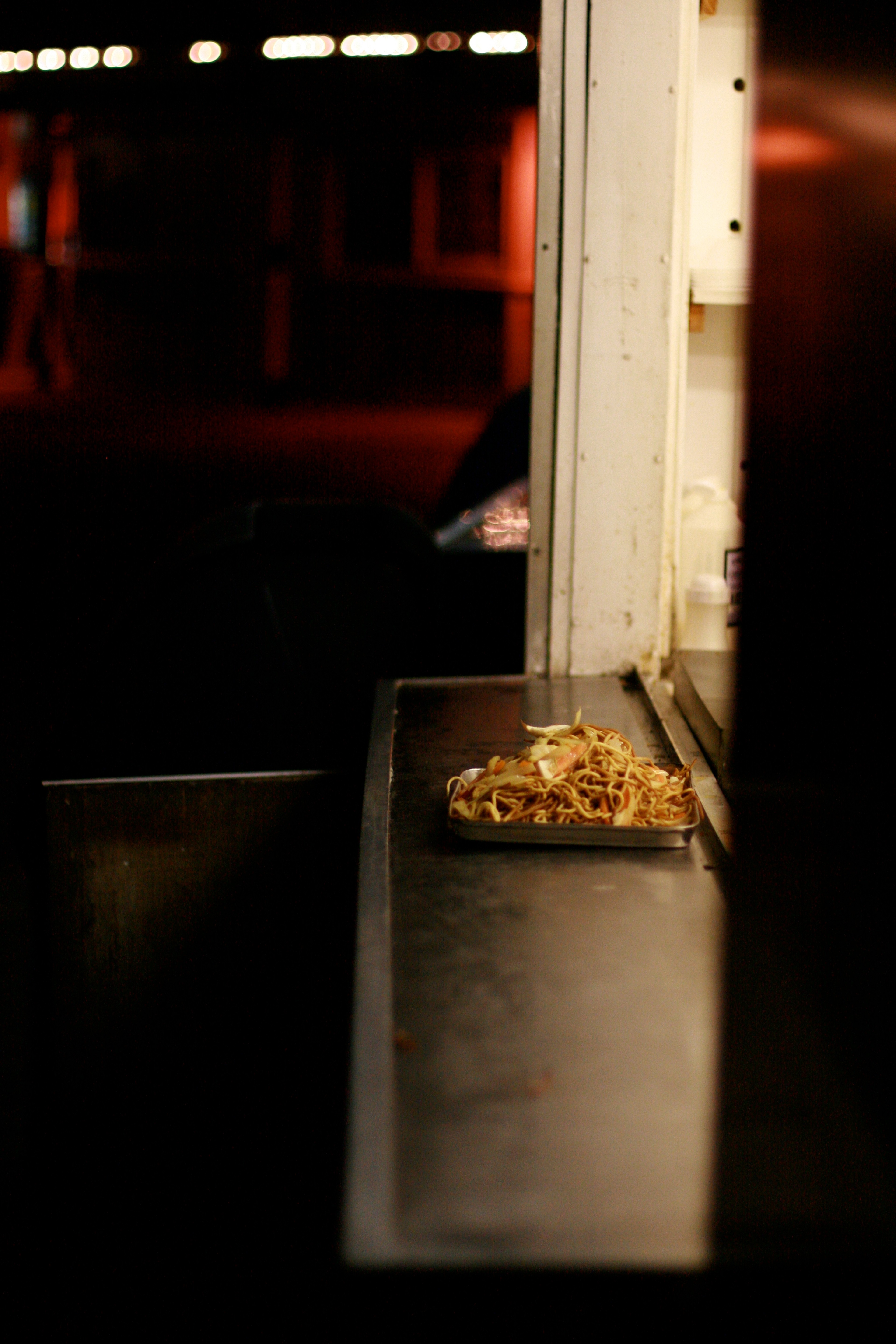 A narrow doorway opens into a dim room with a small illuminated display.