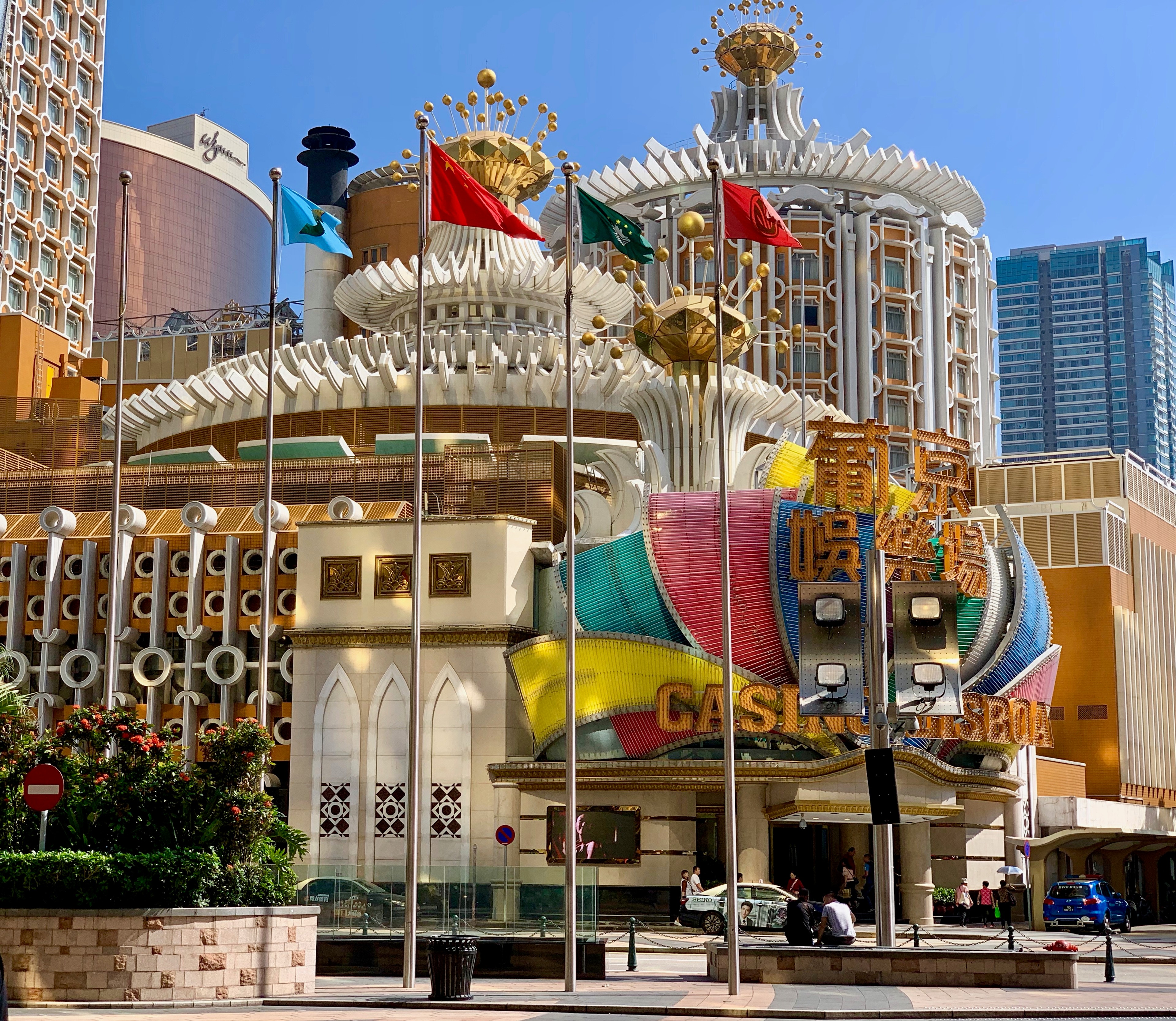 Ornate Macau casino façade topped with a golden ship and Chinese-style roof.