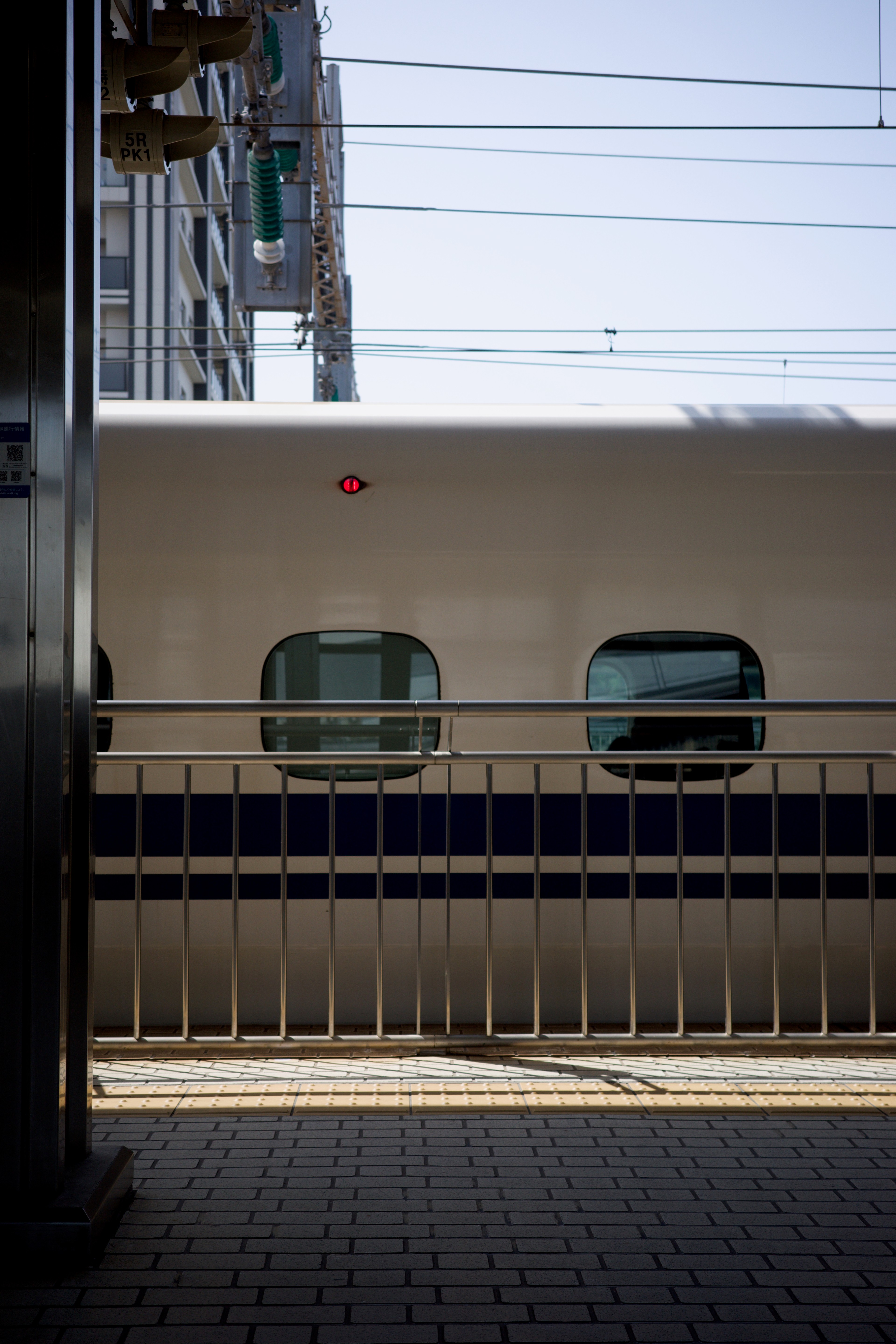 A train is seen through station columns.