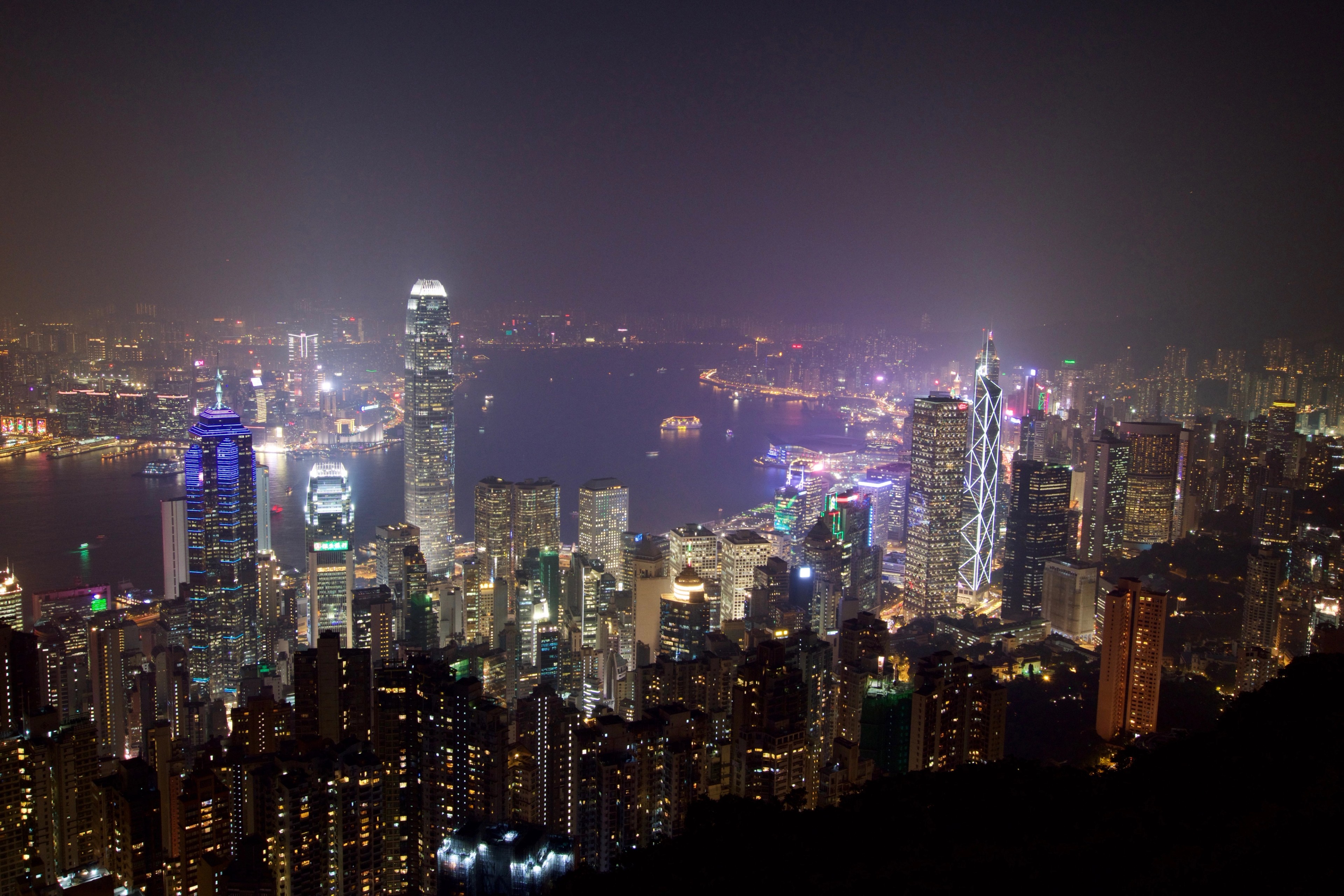 Hong Kong’s illuminated skyline fills the night view from a hillside.