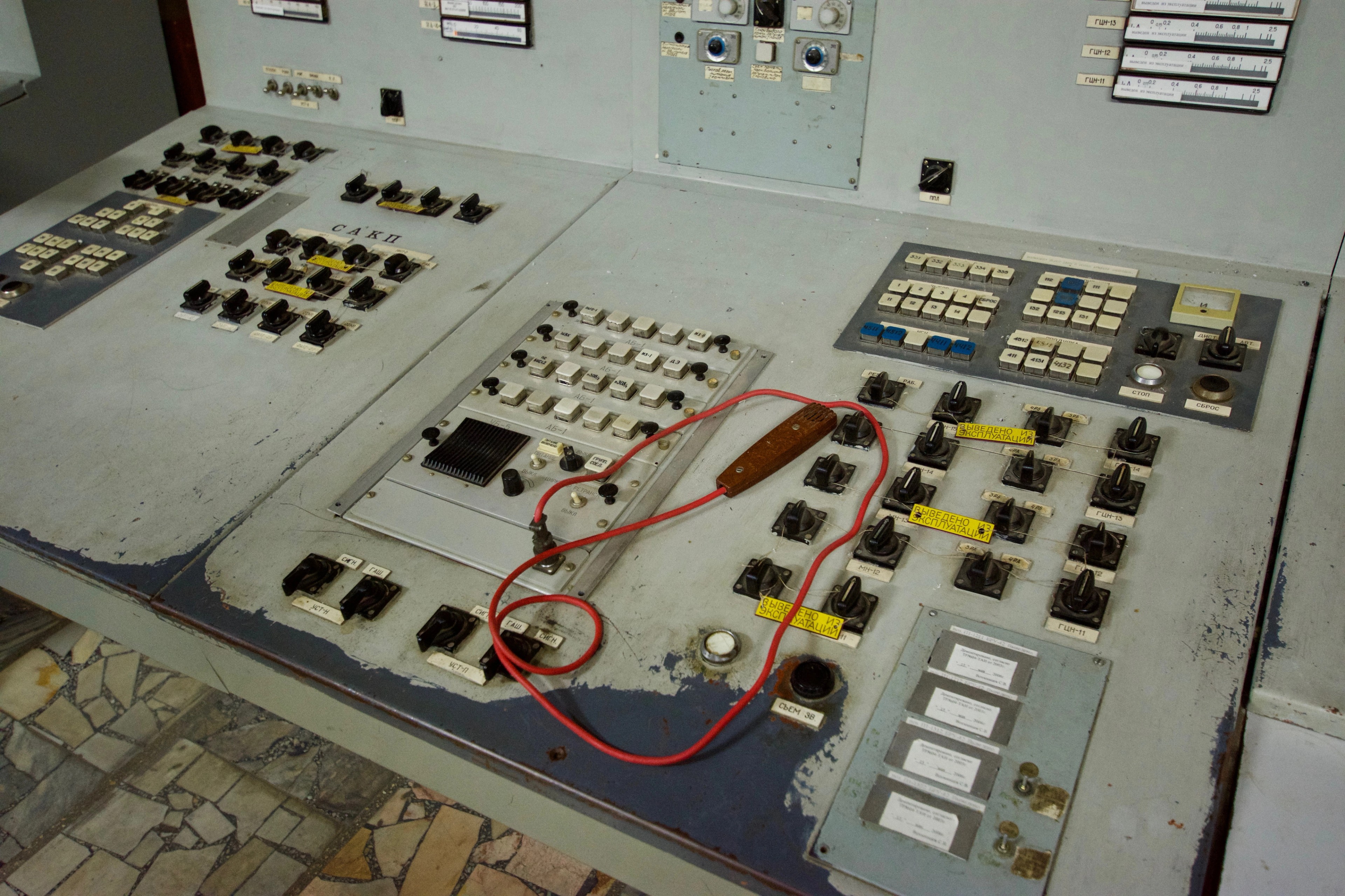 Colored wires lie across switches on a control desk.