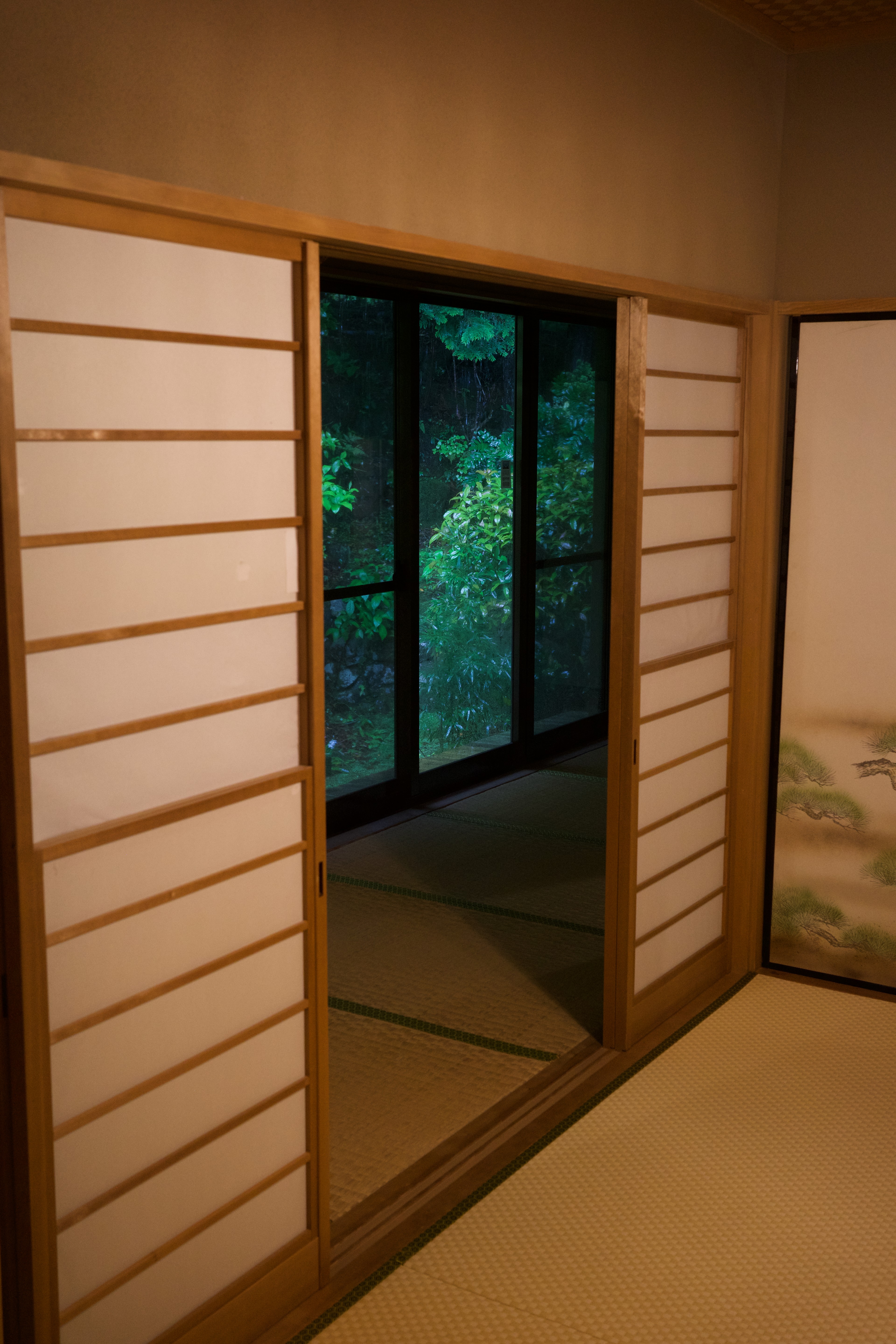 A wooden interior corridor with a sliding shoji door.