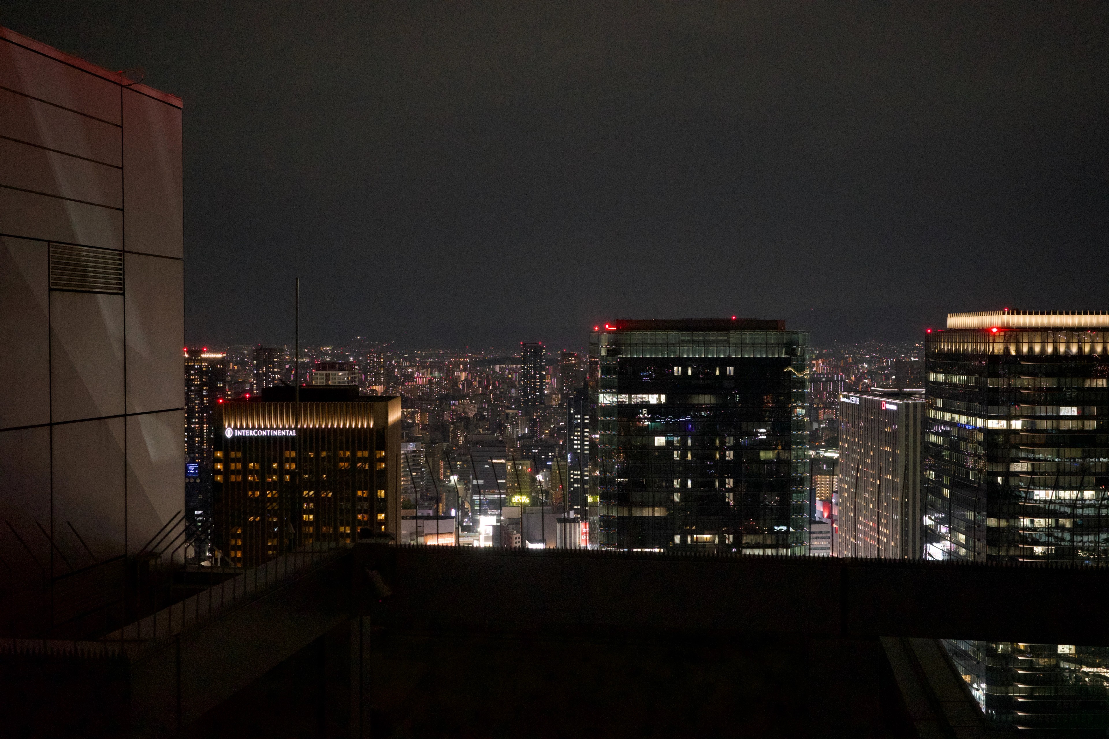 A nighttime skyline seen through a glass window.