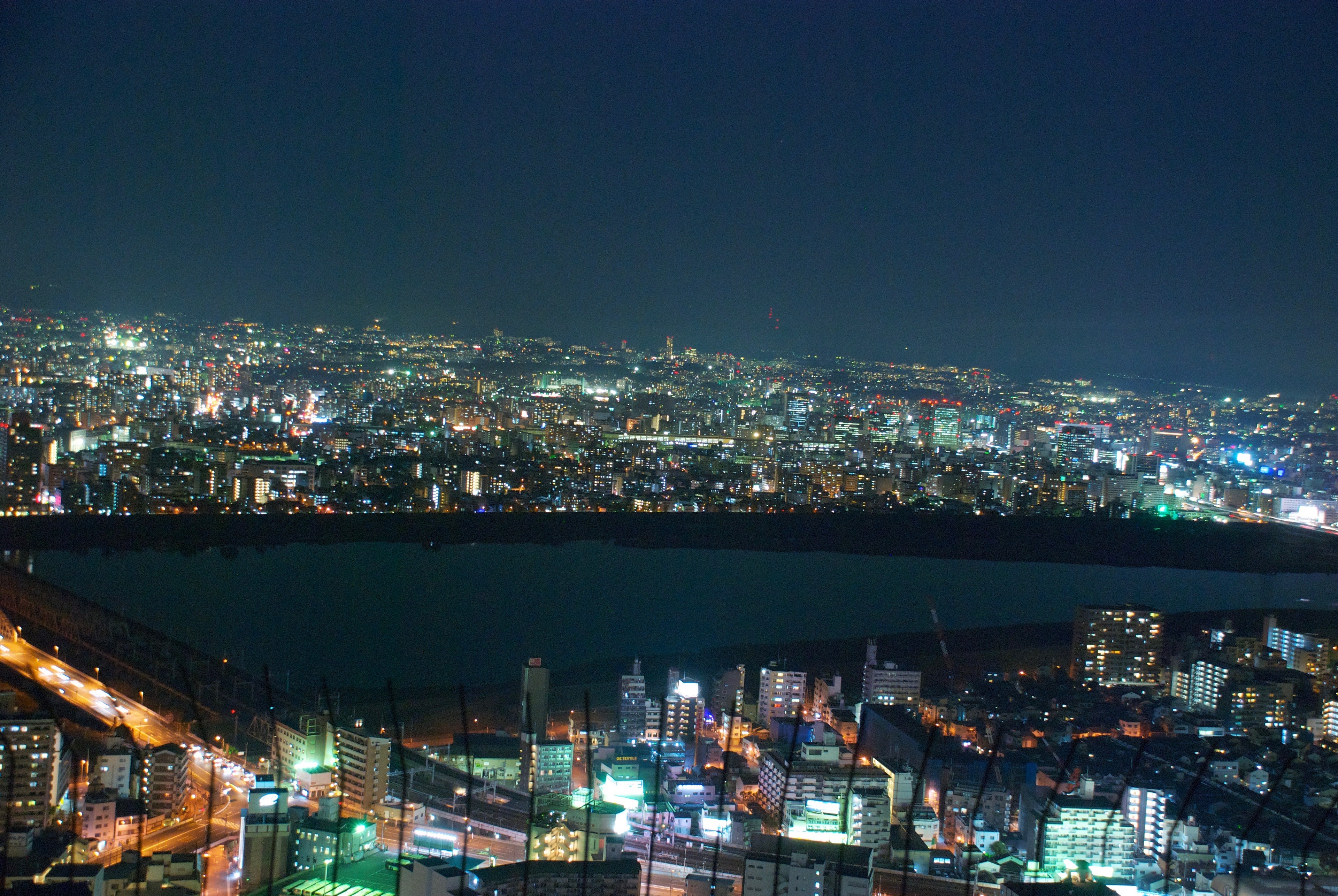 Osaka’s city lights spread across the horizon after dark.