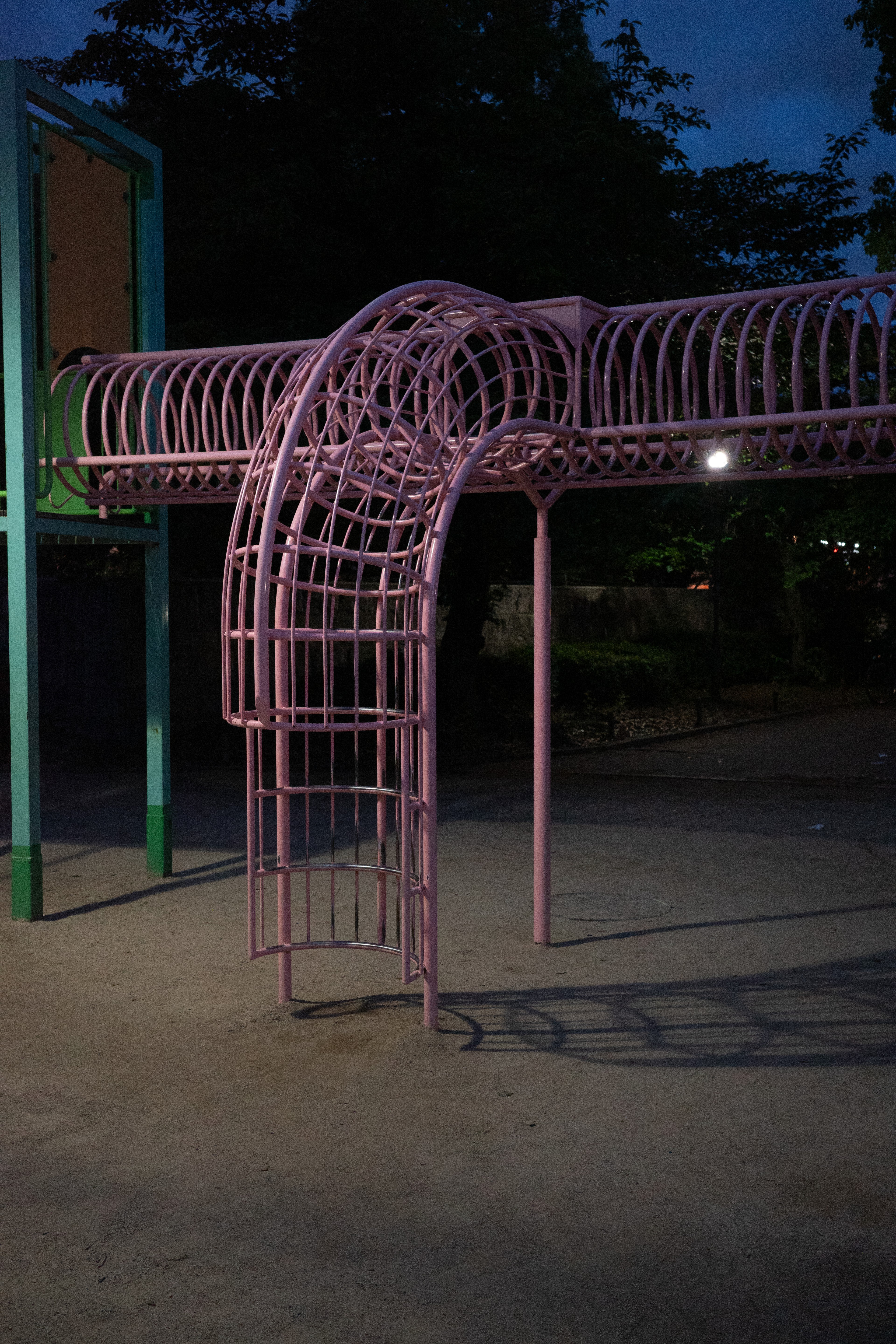 A pink tubular play structure glows in the dark.