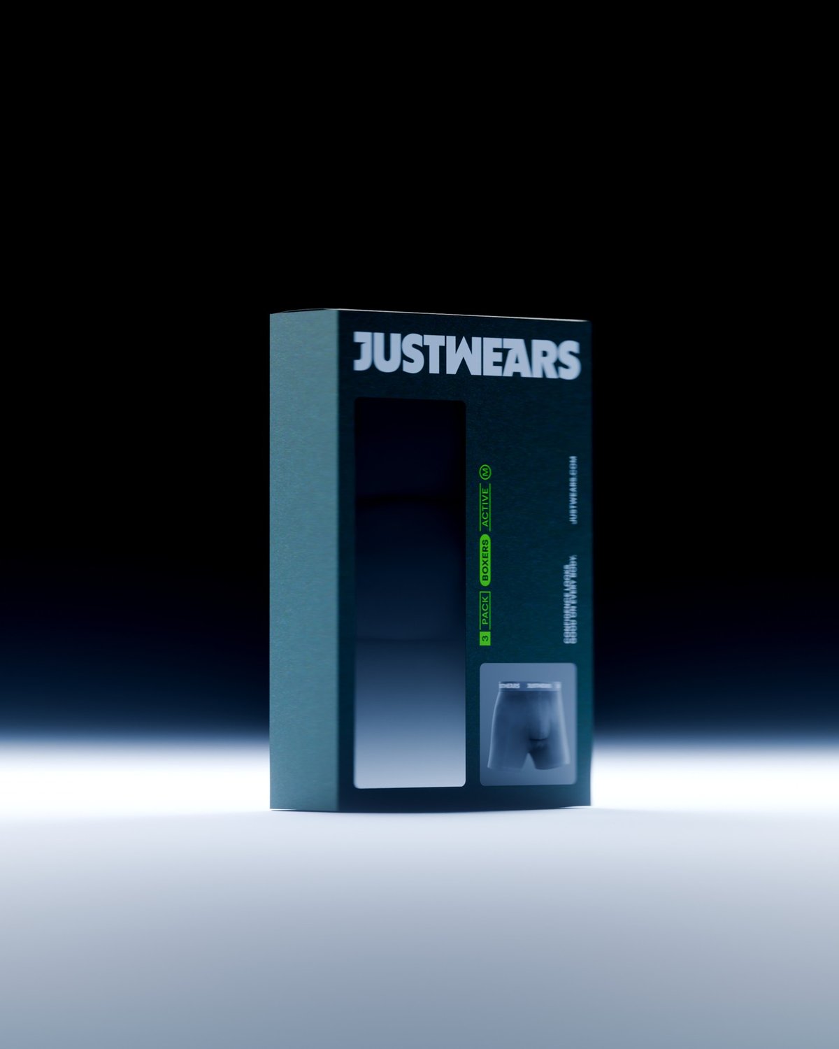 A dark teal box of JustWears Active 3 Pack boxer briefs is shown against a black background. The box features the brand name, a clear window displaying the briefs, and a small image of the briefs.