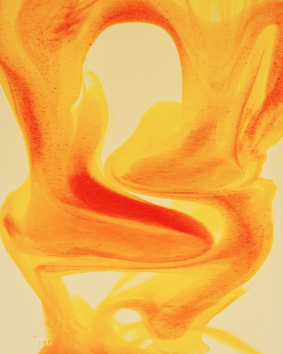 Abstract orange and yellow swirls and streaks on a light background.