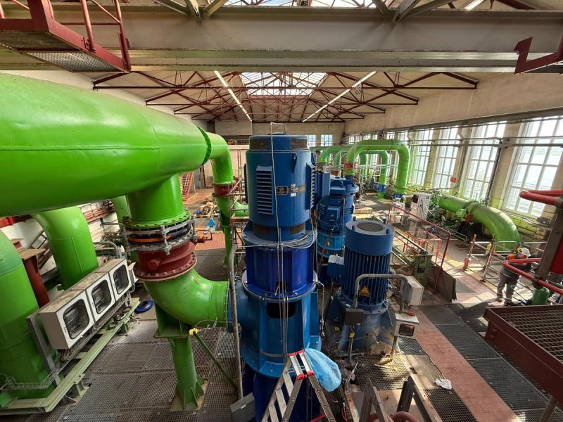 Large blue vertical river water pumps in the pump hall of the CURRENTA plant