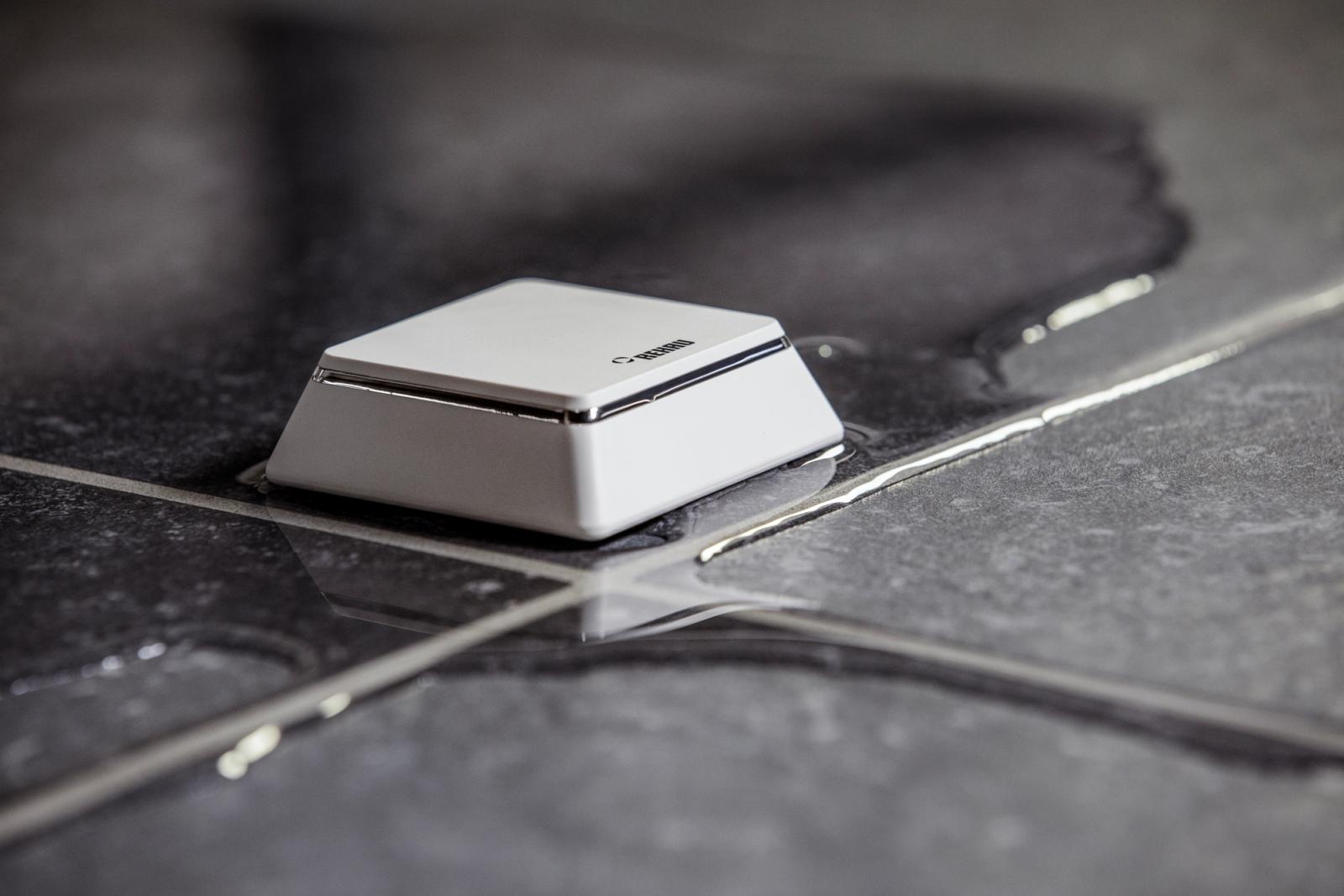 Small IoT water sensor on wet tiles for leak detection