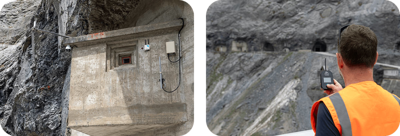 Links ein Betonhäuschen an der Felswand mit Antenne und Gateway-Gehäuse, rechts ein Techniker in Warnweste, der mit einem Handgerät die Funkabdeckung an der Staumauer prüft