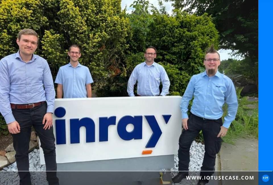 Employee in front of the inray company sign, whose OPC routers are deployed on edge devices via the container platform Portainer