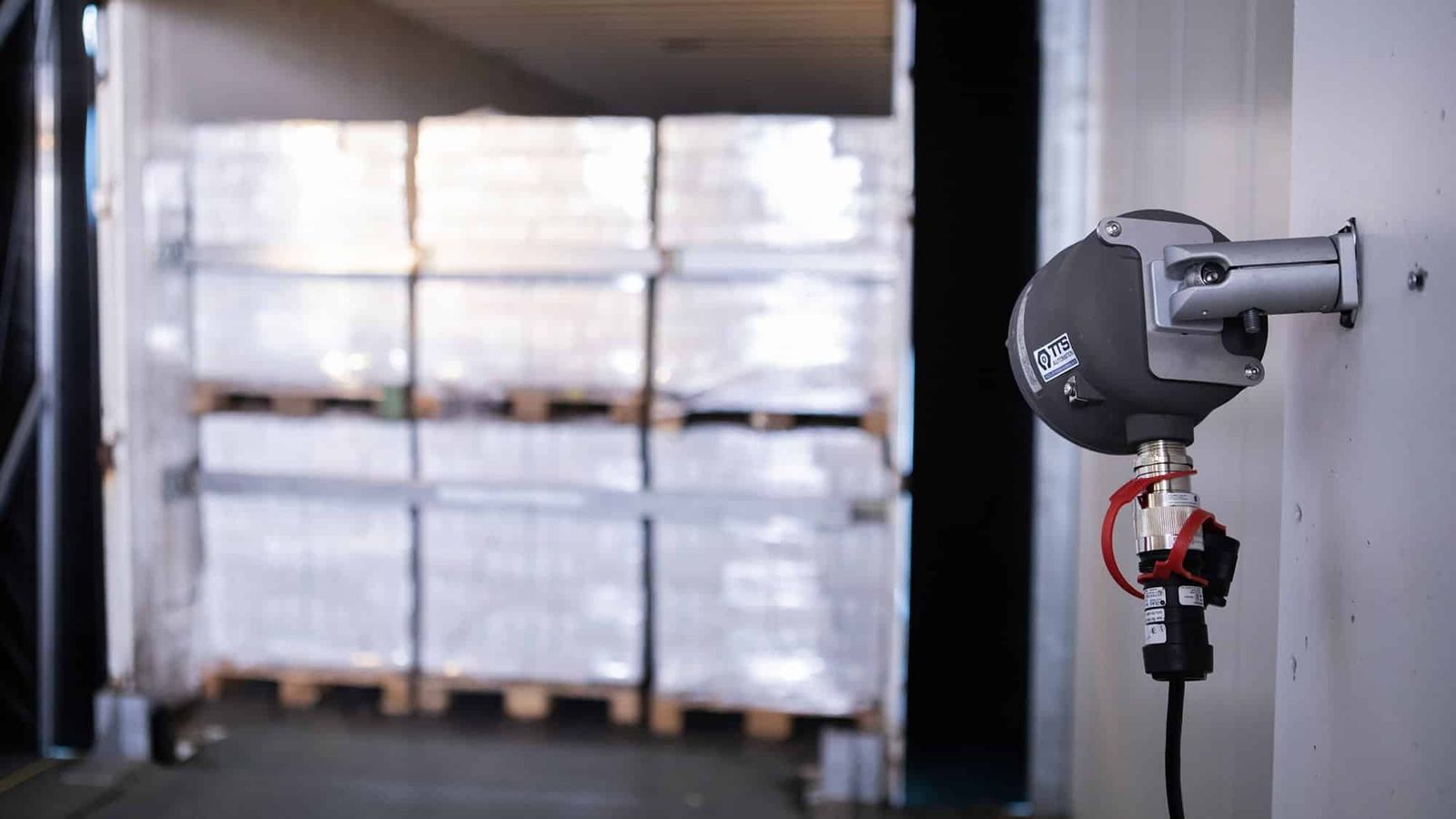 Cable pull sensor at loading dock for automated loading documentation with pallets in background