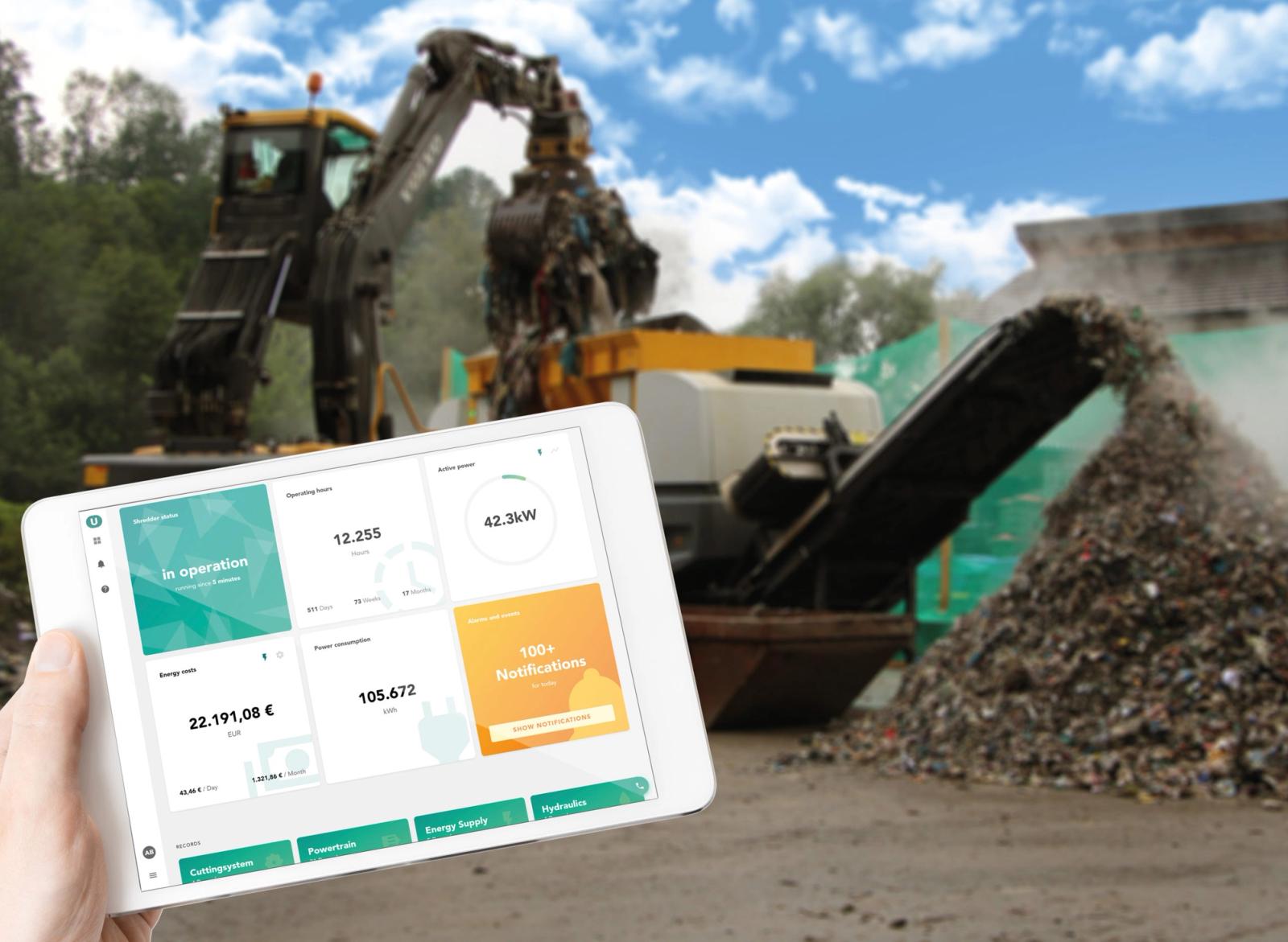 Tablet with shredder machine dashboard showing energy consumption and operating status
