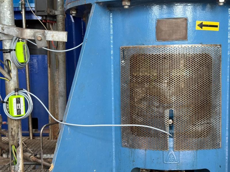 Close-up of mounted LoRaWAN vibration sensors on the housing of a river water pump