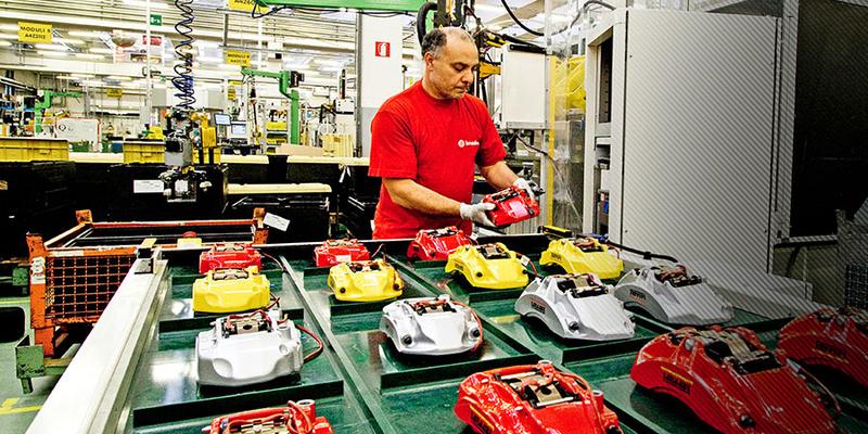 Brembo brake caliper assembly: various colored brake calipers on production table