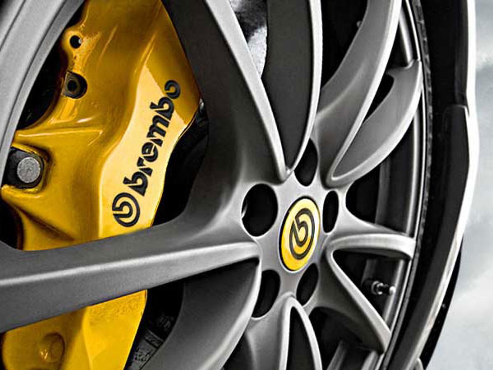 Brembo yellow high-performance brake caliper in wheel rim - close-up braking system