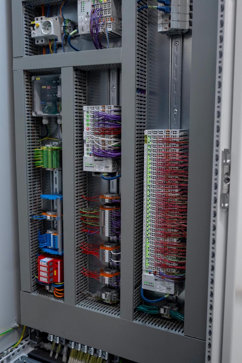 Open control cabinet with terminals and control modules in data center