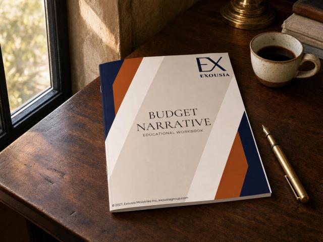 The Budget Narrative workbook on a walnut desk beside a sunlit window, with a brass fountain pen and a cup of black coffee.