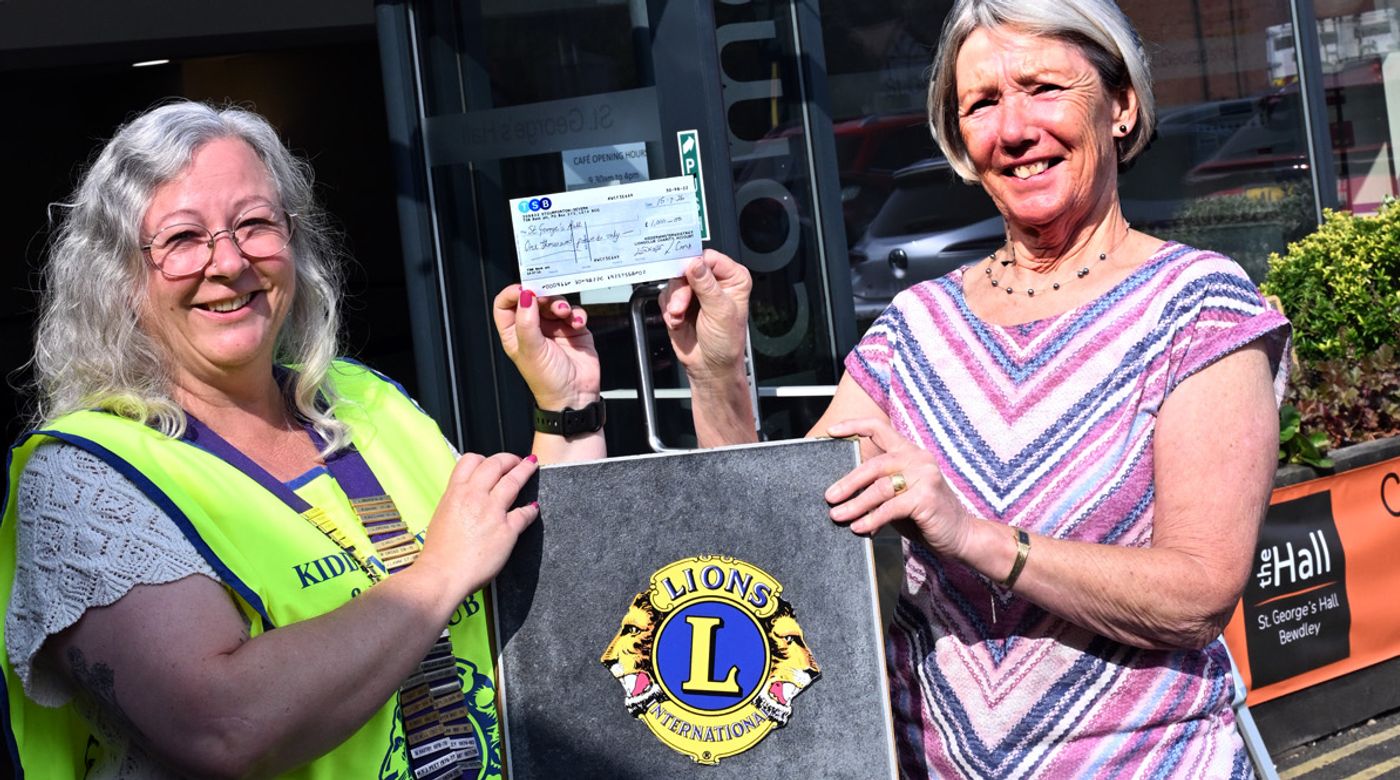 Lions president giving cheque to SGH Trustee