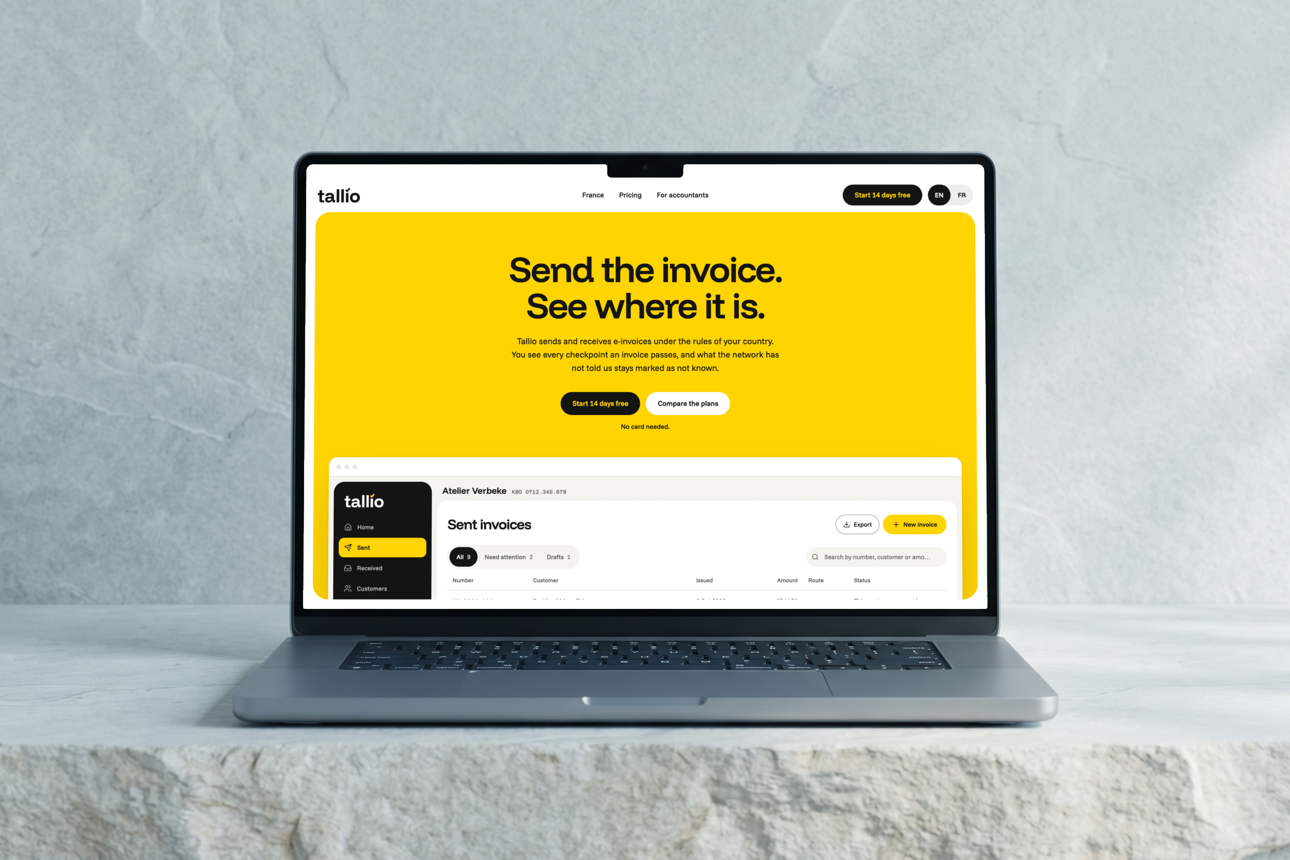 Laptop on pale stone showing the Tallio home page: a yellow first screen with the headline “Send the invoice. See where it is.” and the portal below it