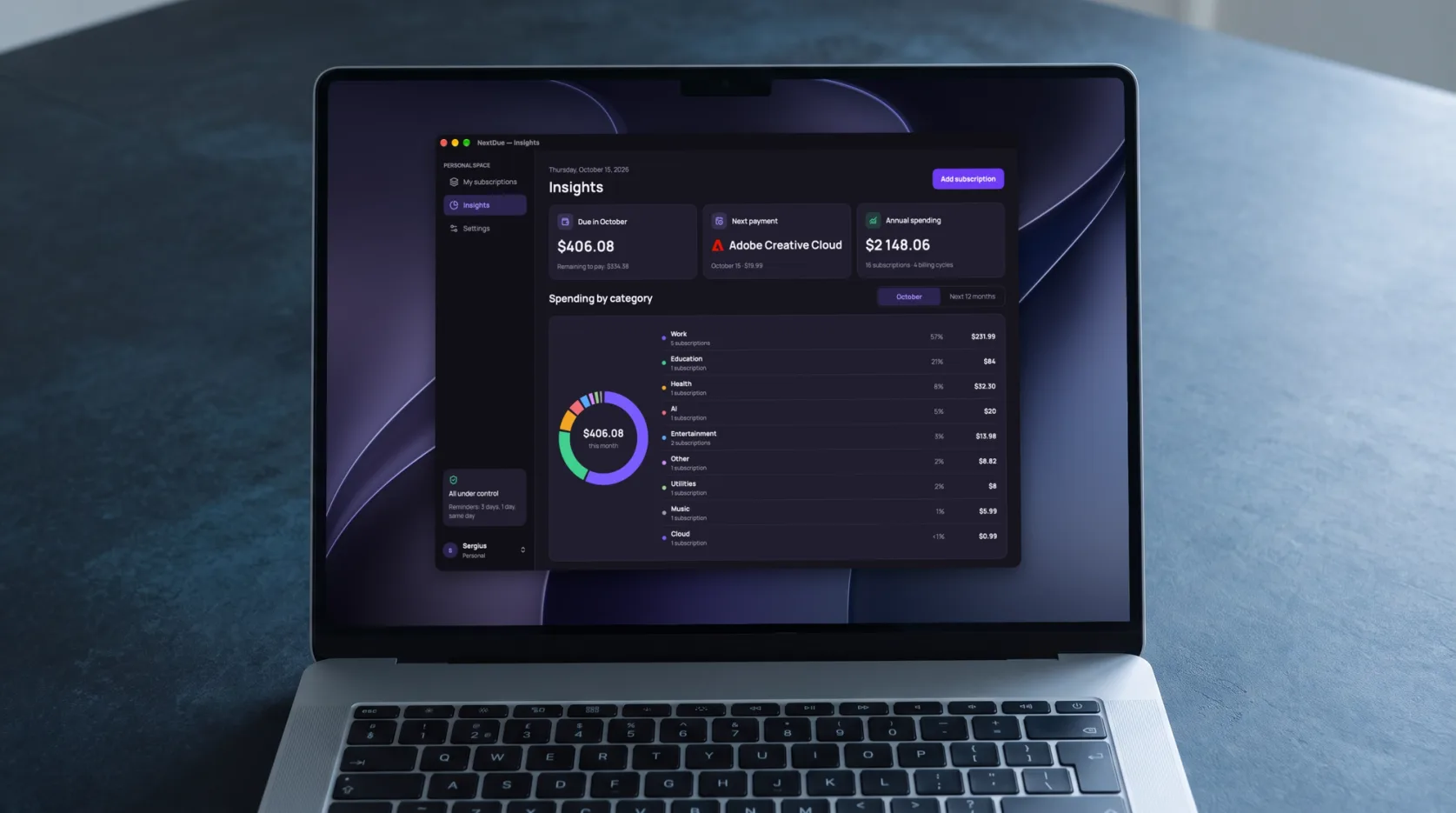 Laptop on a dark desk showing NextDue insights: a donut chart of spending by category and a list with shares and amounts