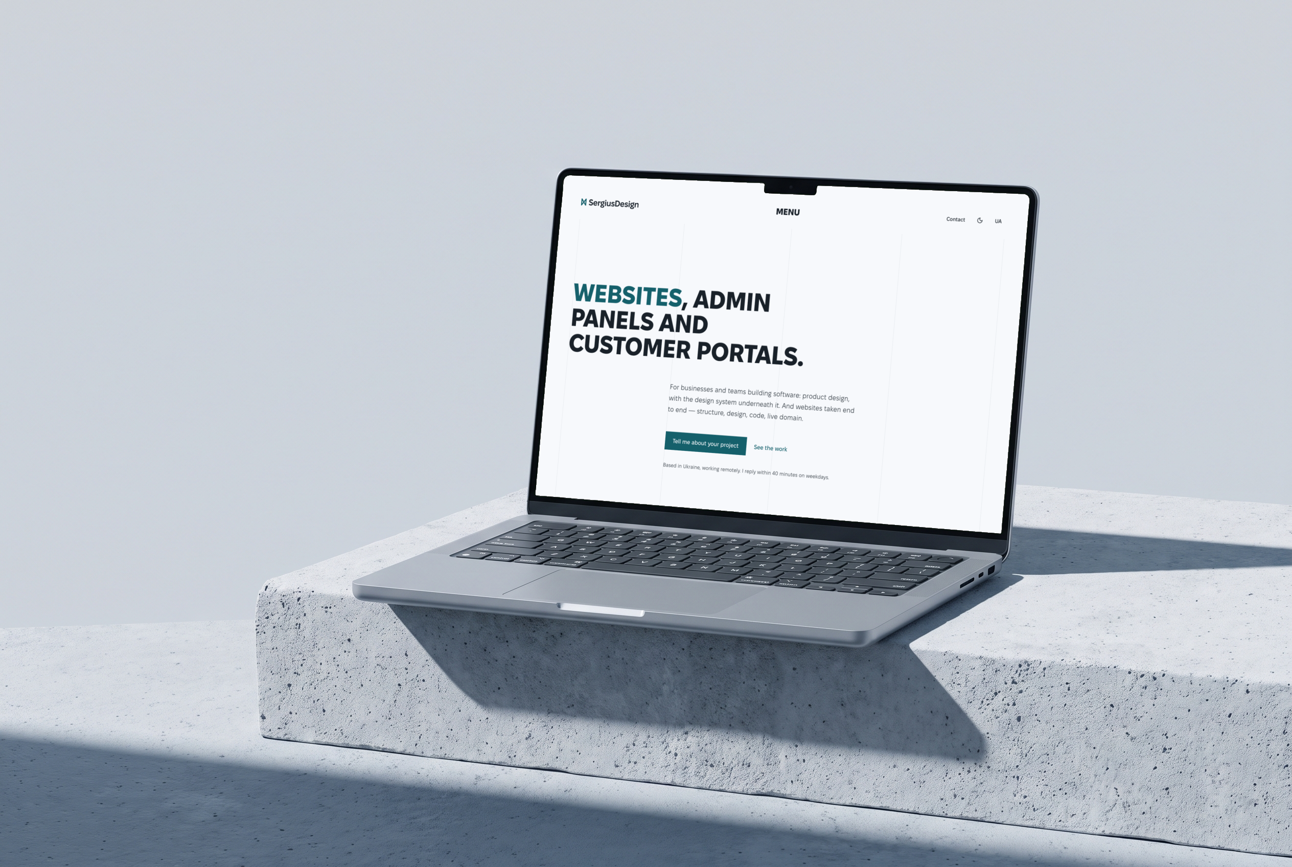 Laptop on a concrete block with the sergiusdesign.com home page: the headline “Websites, admin panels and customer portals” and the “Tell me about your project” button, light theme