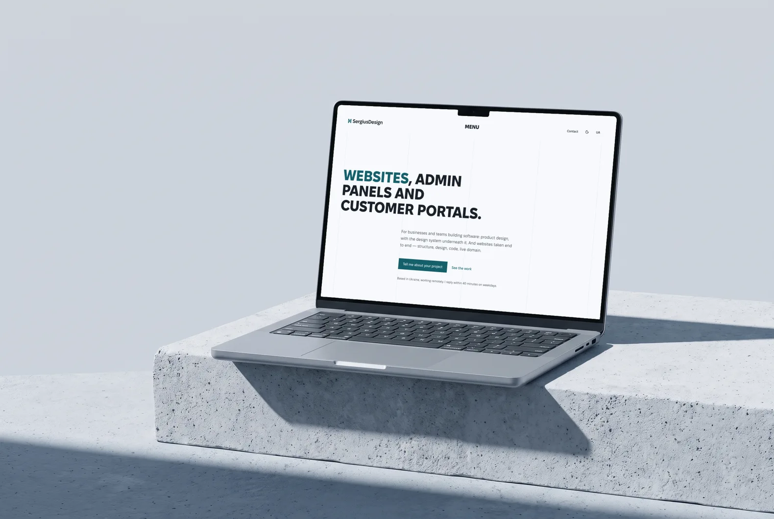 Laptop on a concrete block with the sergiusdesign.com home page: the headline “Websites, admin panels and customer portals” and the “Tell me about your project” button, light theme