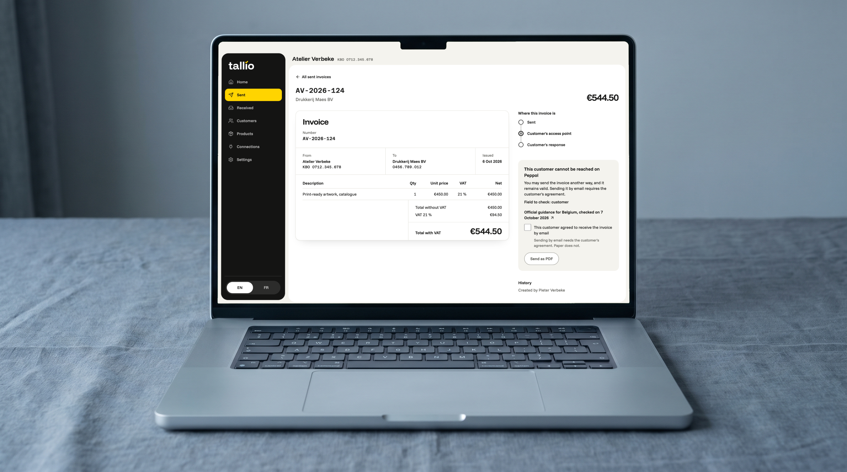Laptop on grey linen showing a Tallio invoice as a document and the “Where this invoice is” panel: the customer can’t be reached on Peppol, what to check and what to do