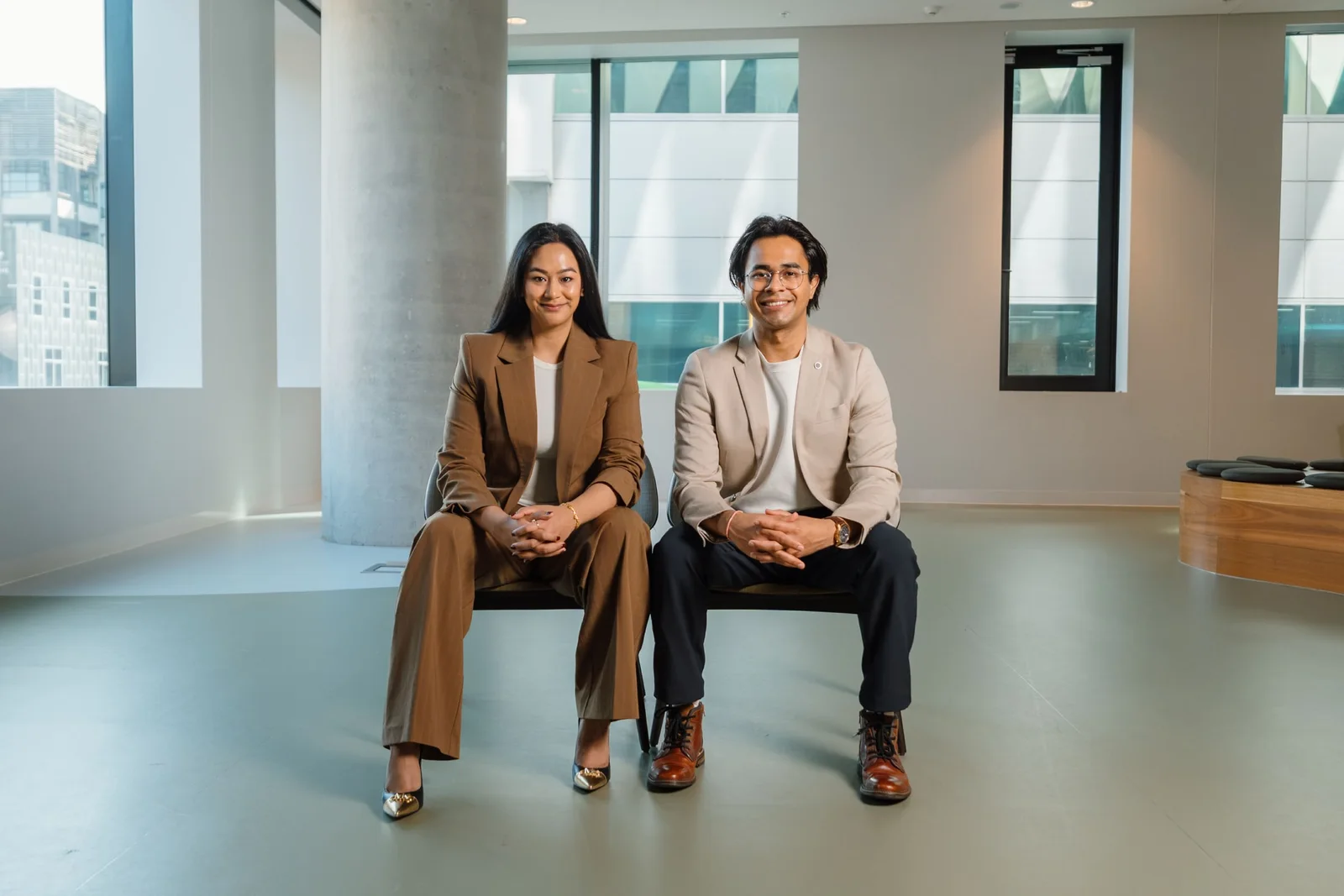Syncrowin co-founders Aisshwarya Kansakaar and Jaideep Upadhyay seated side by side in a bright office