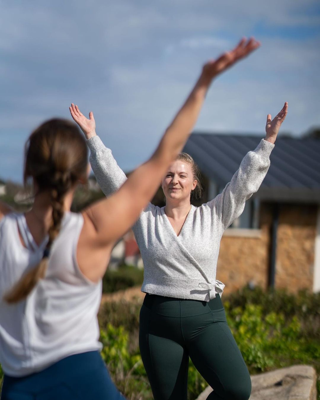 Two ladies doing yoga outside