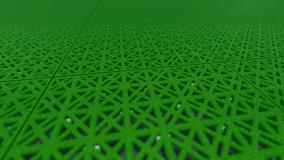 Close-up of green modular sports tiles, showing the open lattice pattern that lets the surface drain through itself.