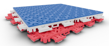 A single modular tile, blue on top and red underneath, tilted to show the interlocking clips on its base.