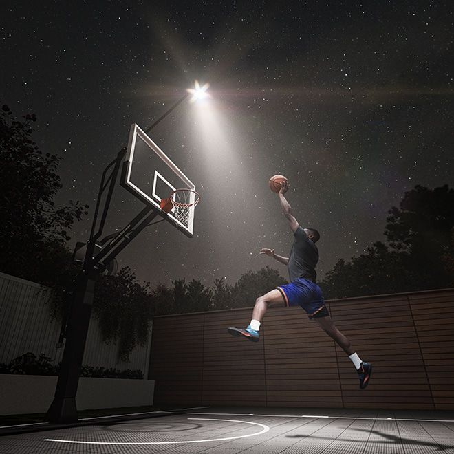 Game Light illuminating a home basketball court after dark