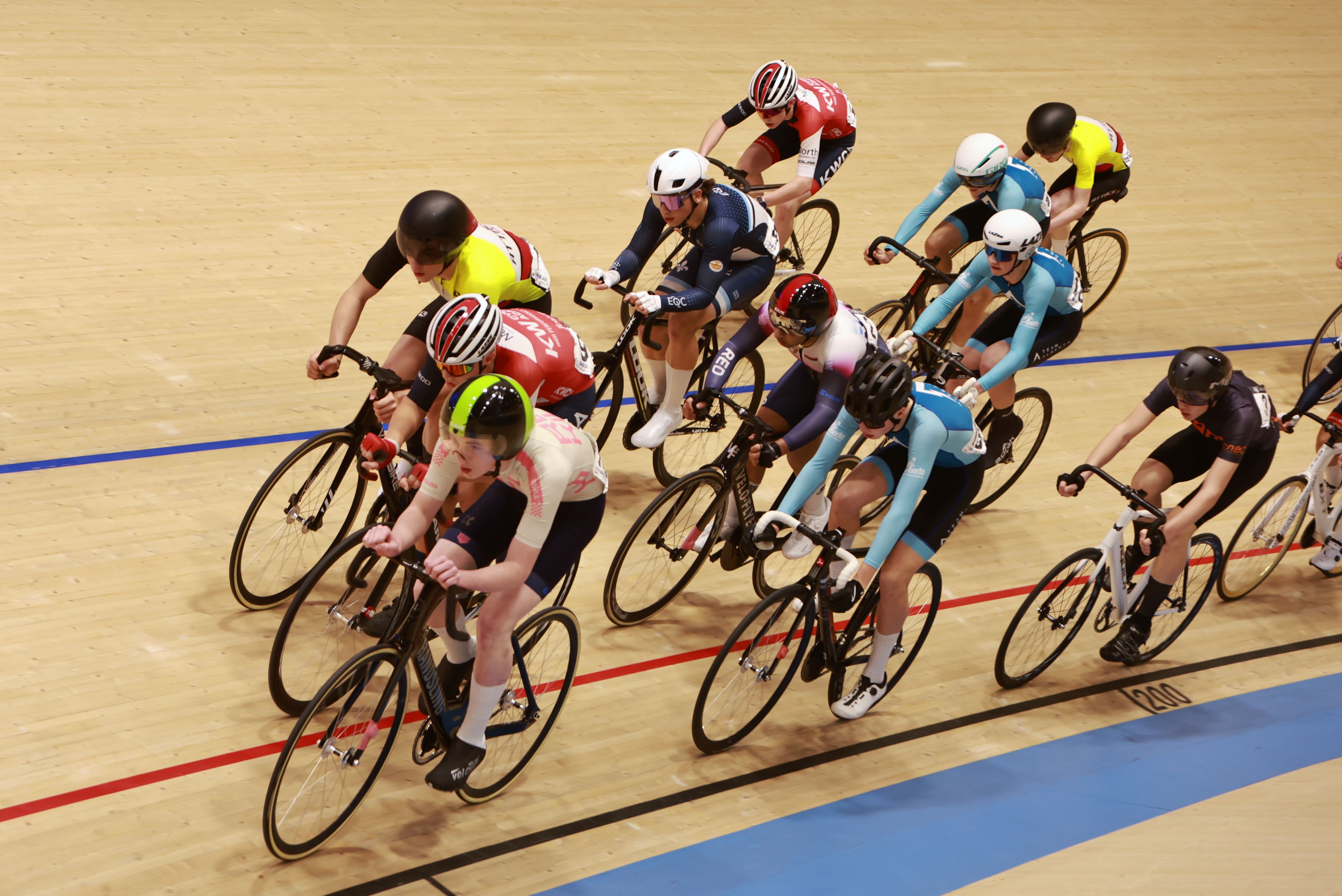 A bunch of riders racing on the boards, seen from the level above the track