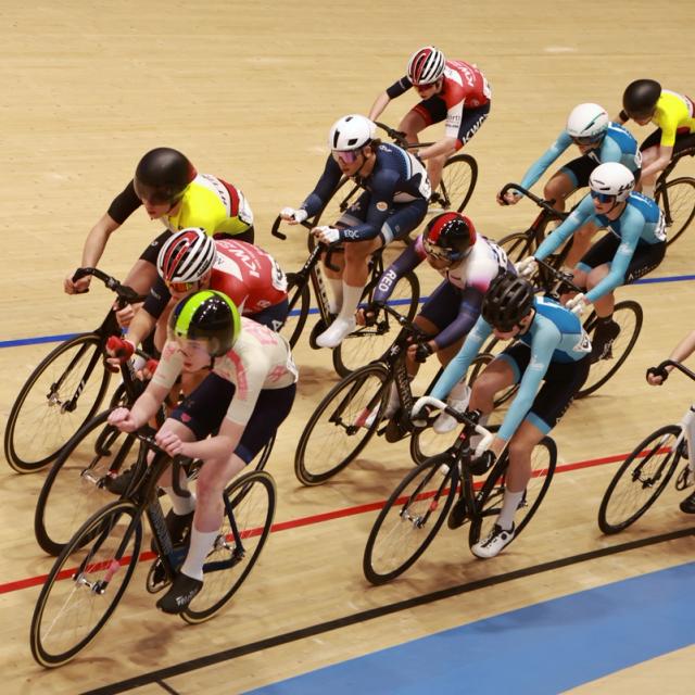 A bunch of riders racing on the boards, seen from the level above the track