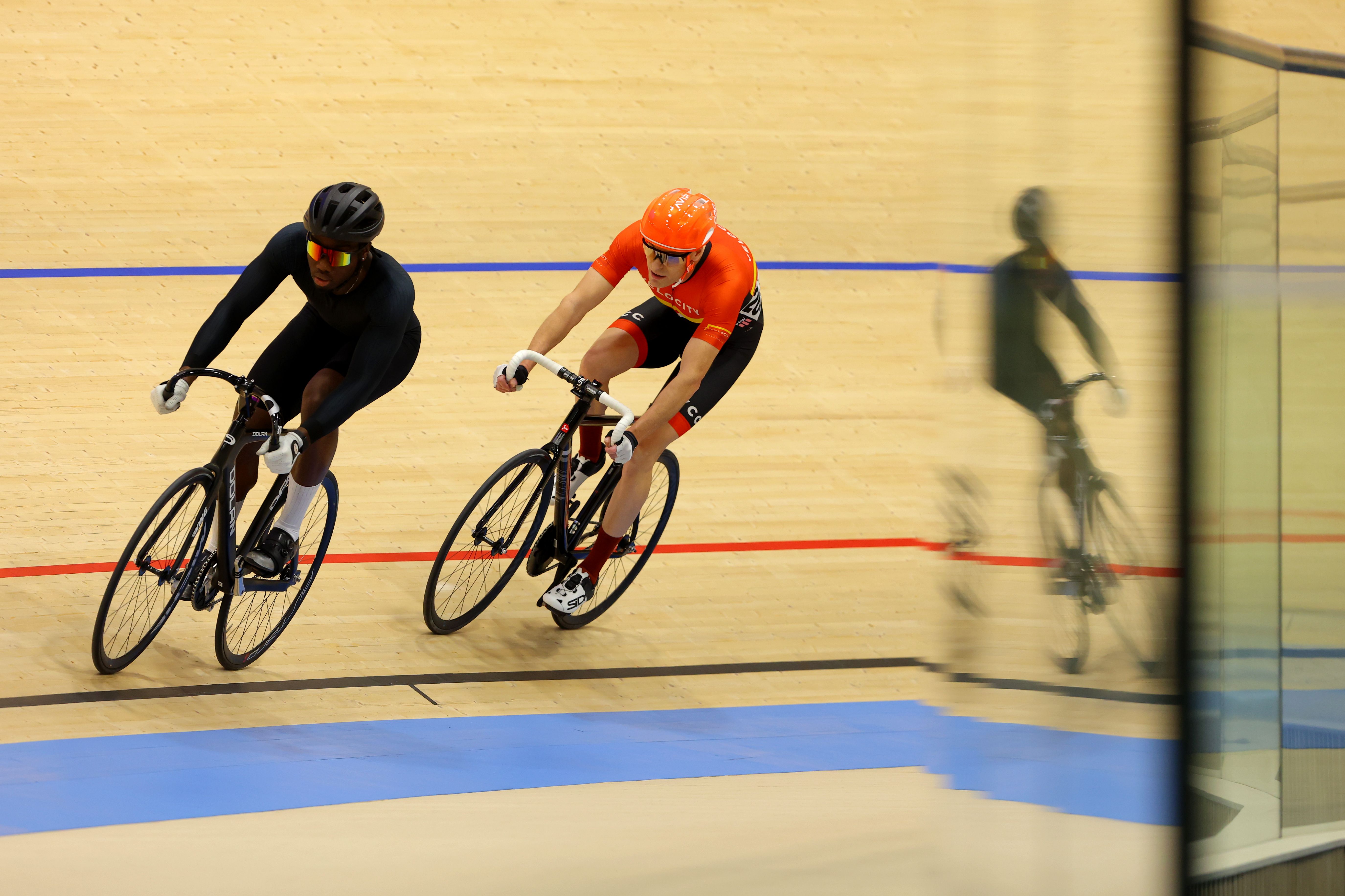 Two riders ride the black line during an open track session
