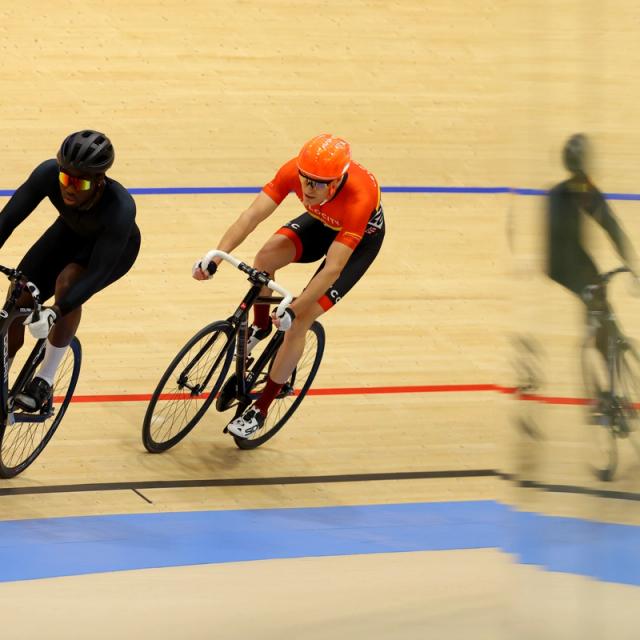 Two riders ride the black line during an open track session